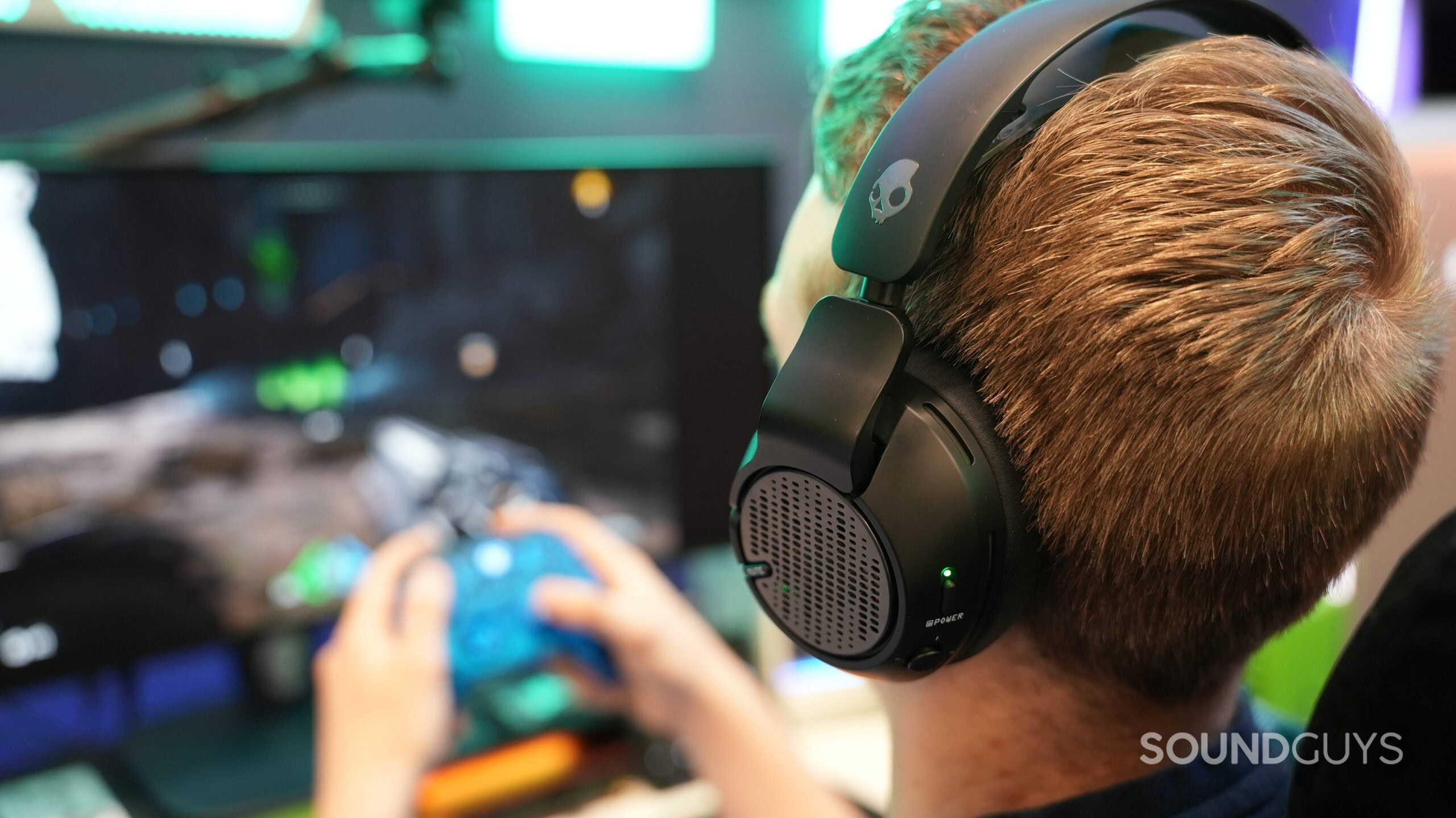 a man wearing the skullcandy crusher plyr 720 while gaming