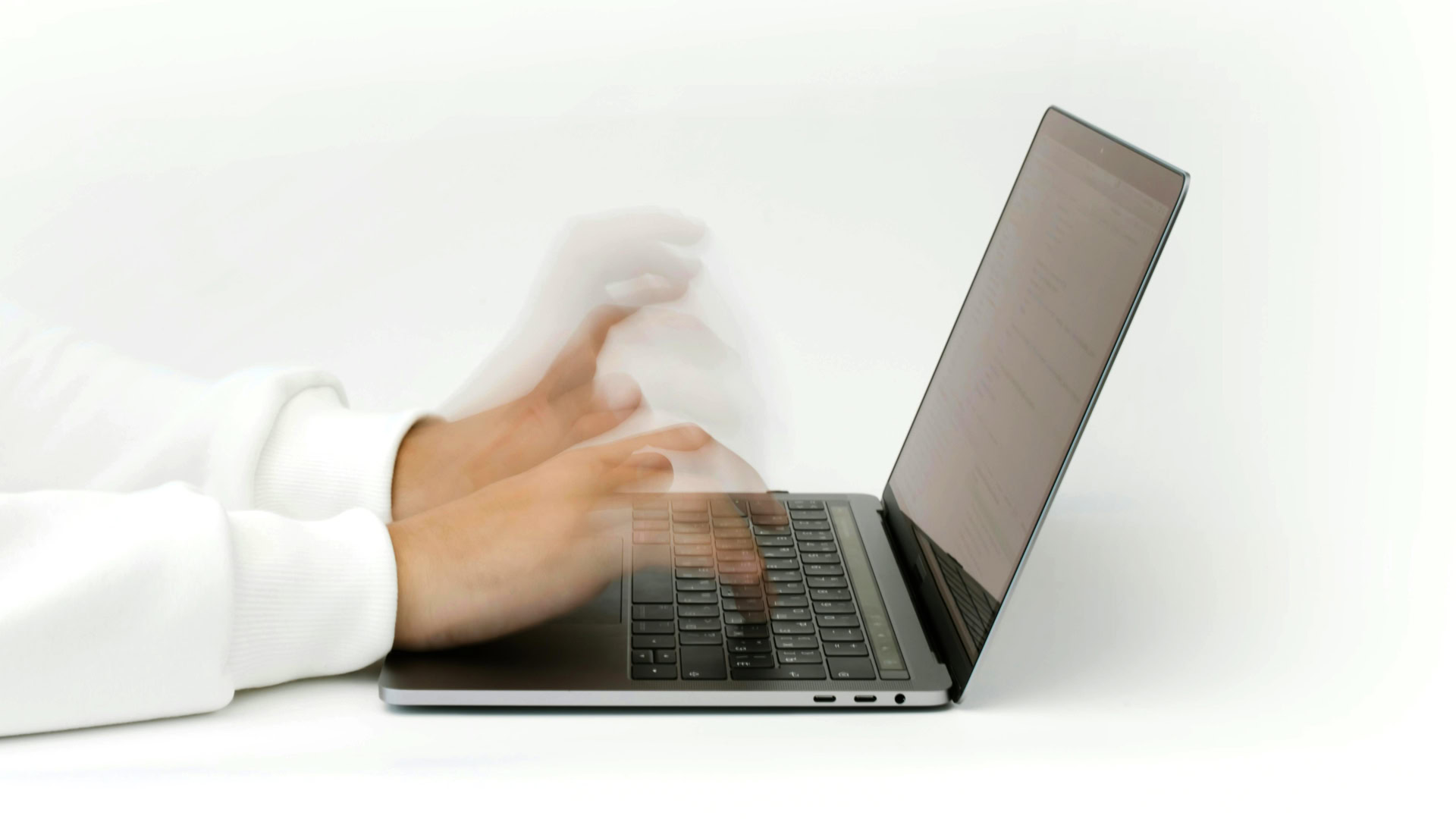 when-things-go-wrong-computer A photo of someone typing quickly on a laptop computer, fast enough to cause motion blur.