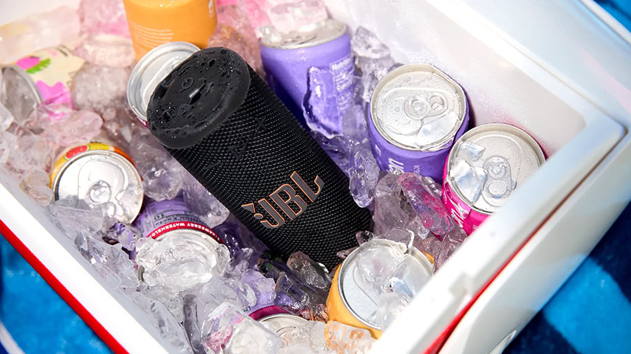 JBL Grip - 1 A JBL Grip speaker in a cooler with ice and drinks.