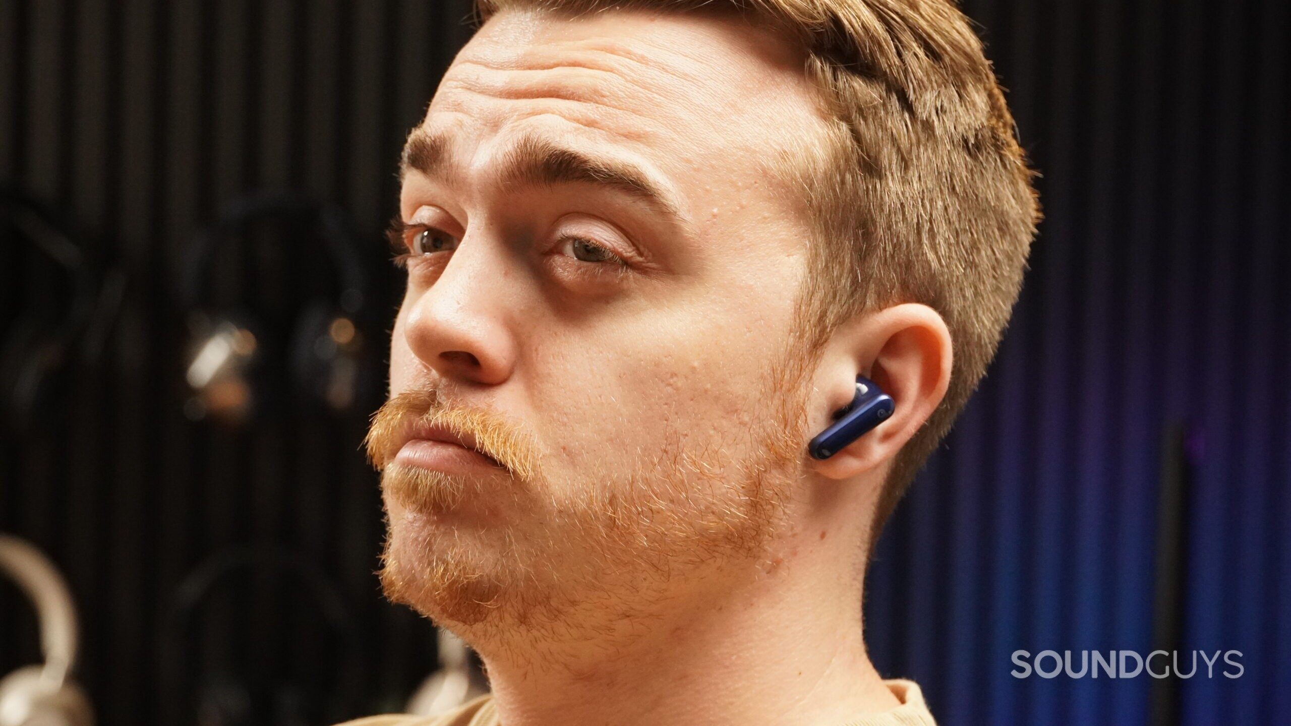 adam unsure face A man reacting to the heavy bass overemphasis of earbuds.