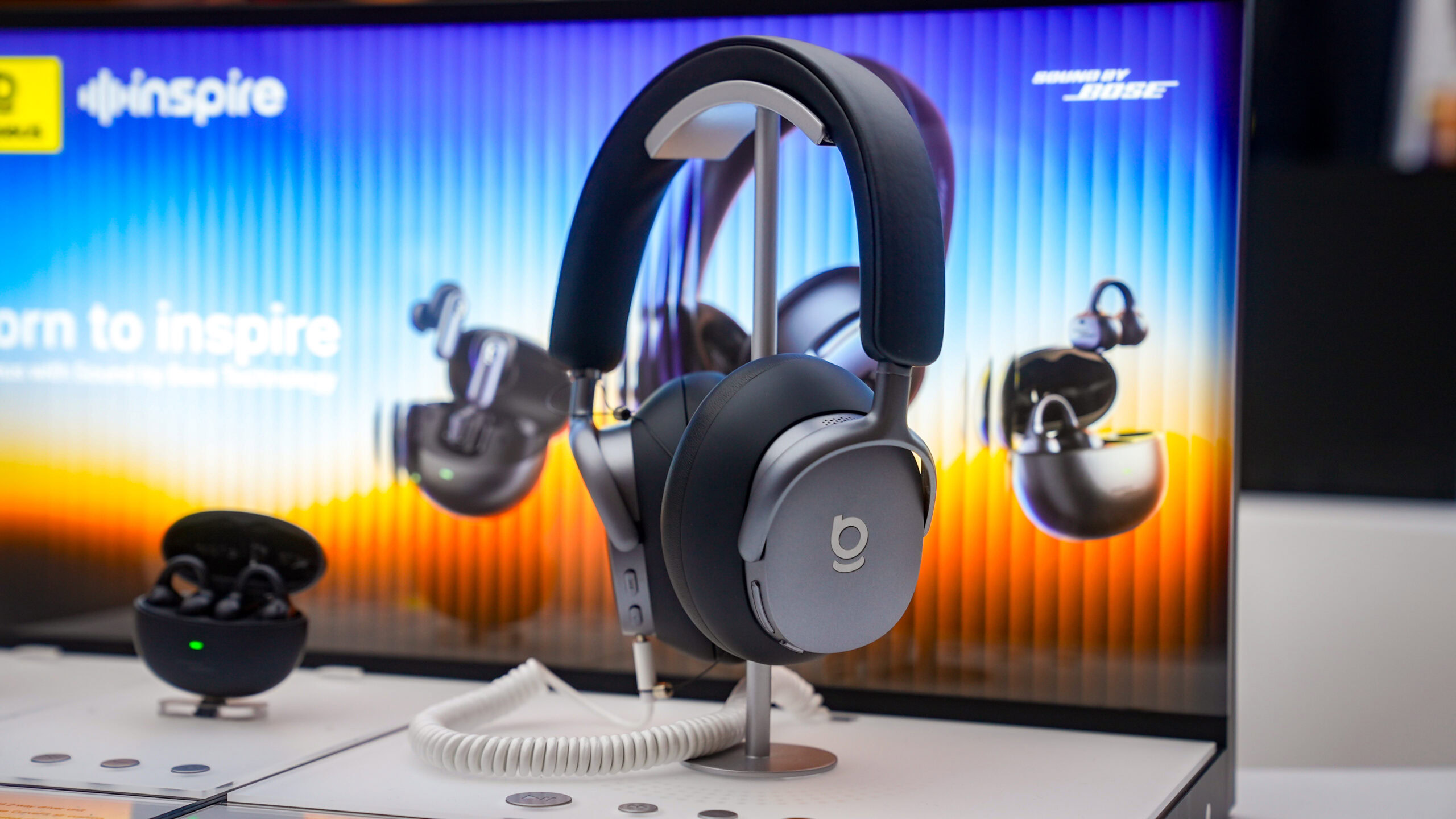 Baseus Inspire XH1 headphones black Baseus Inspire XH1 wireless headphones on headphone stand on table