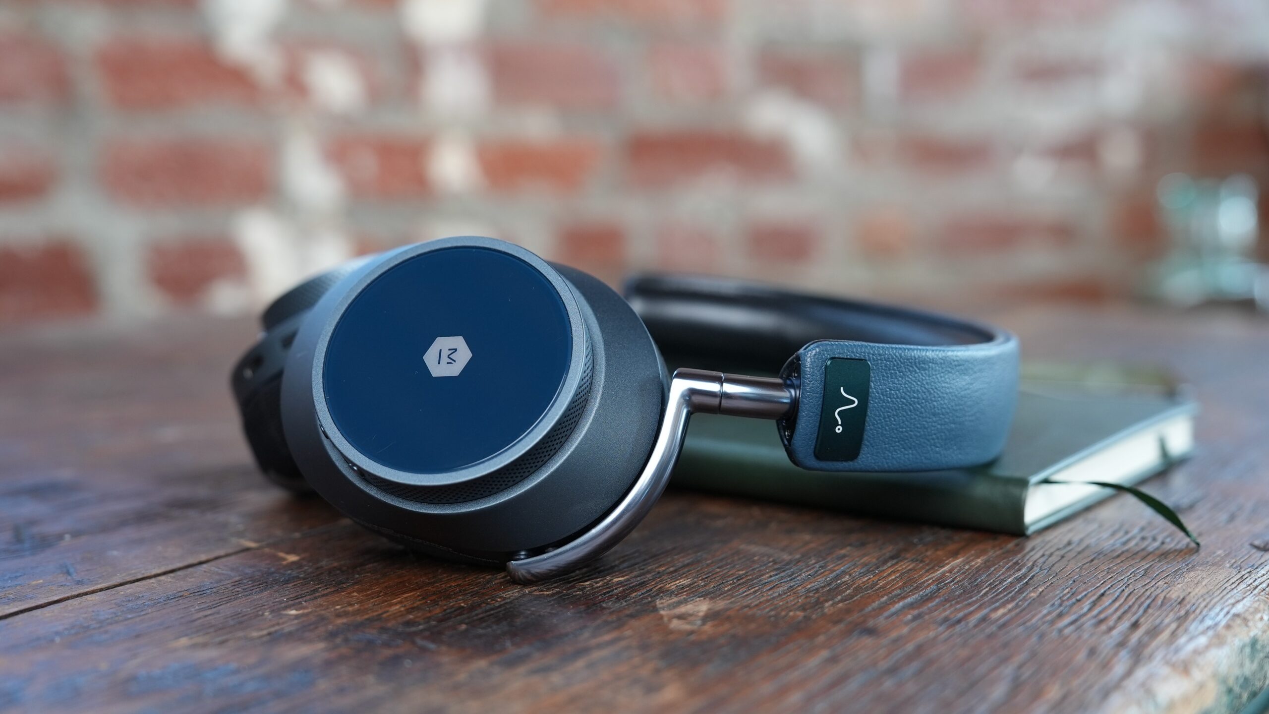 Blue MW75 LT headphones on table