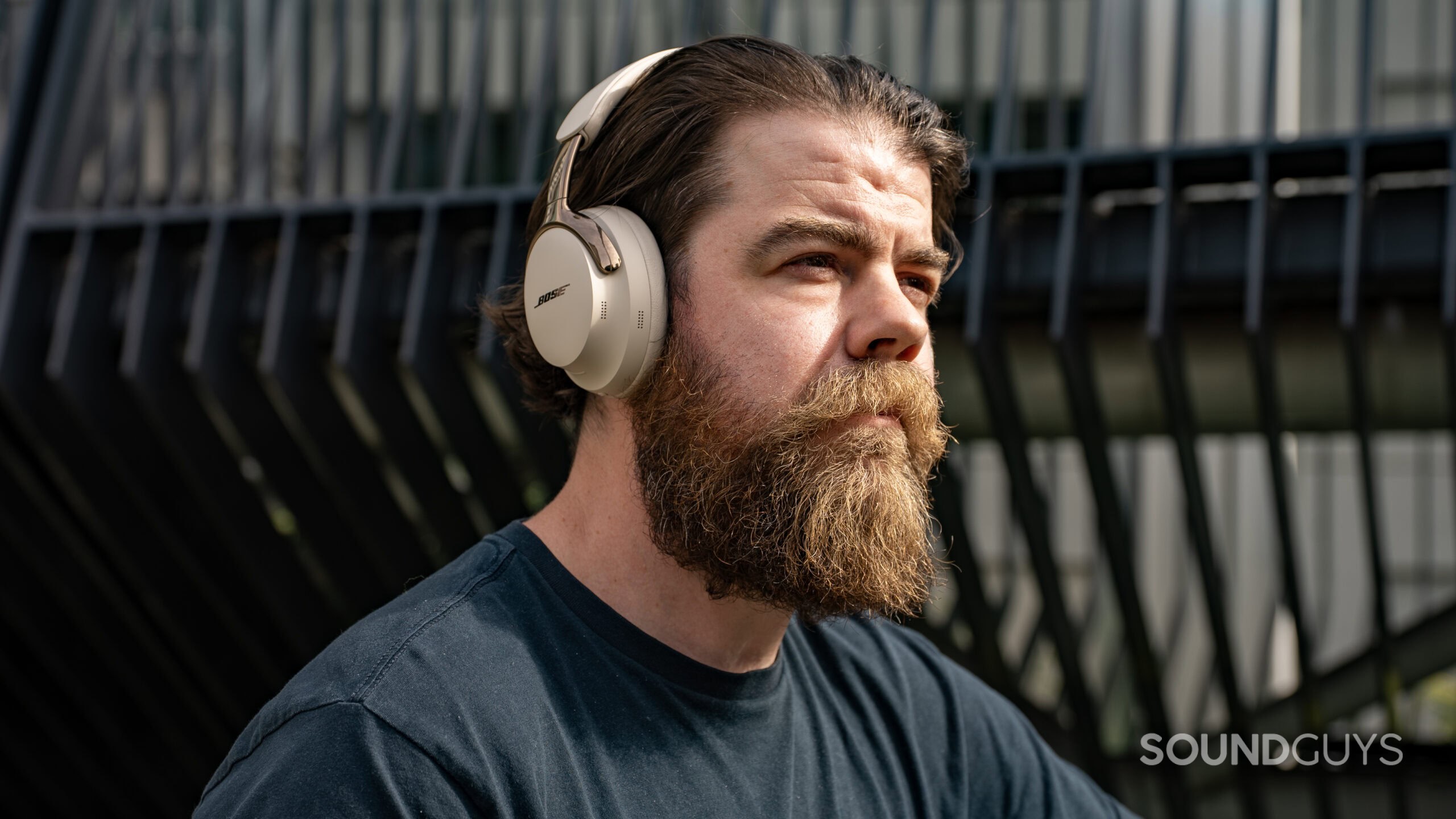 A bearded man listens to music on the Bose QuietComfort Ultra (2nd Gen)