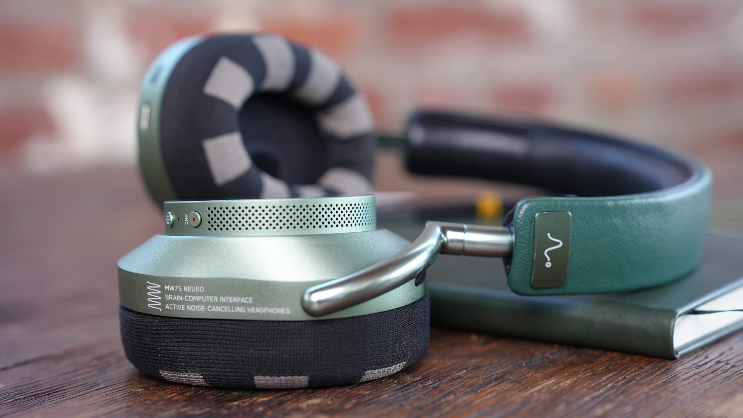 Green MW75 LT headphones on table