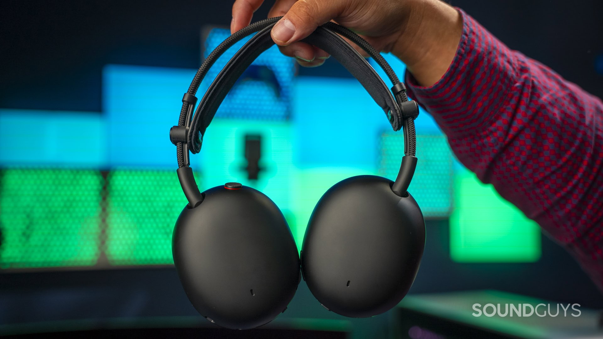A hand holding the Sony Inzone H9 II gaming headset