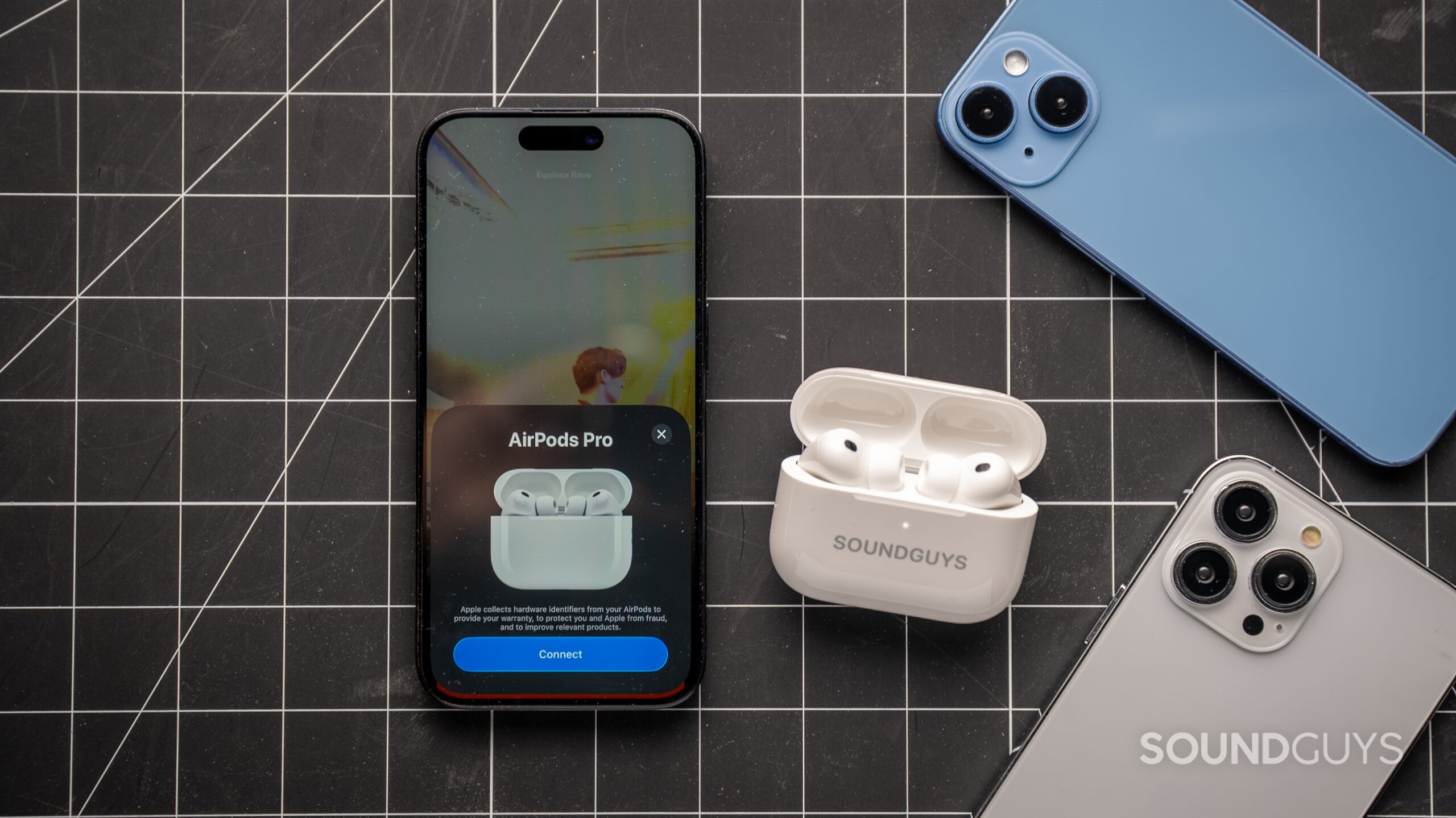AirPods Pro 3 beside iPhone with pairing request card on screen.