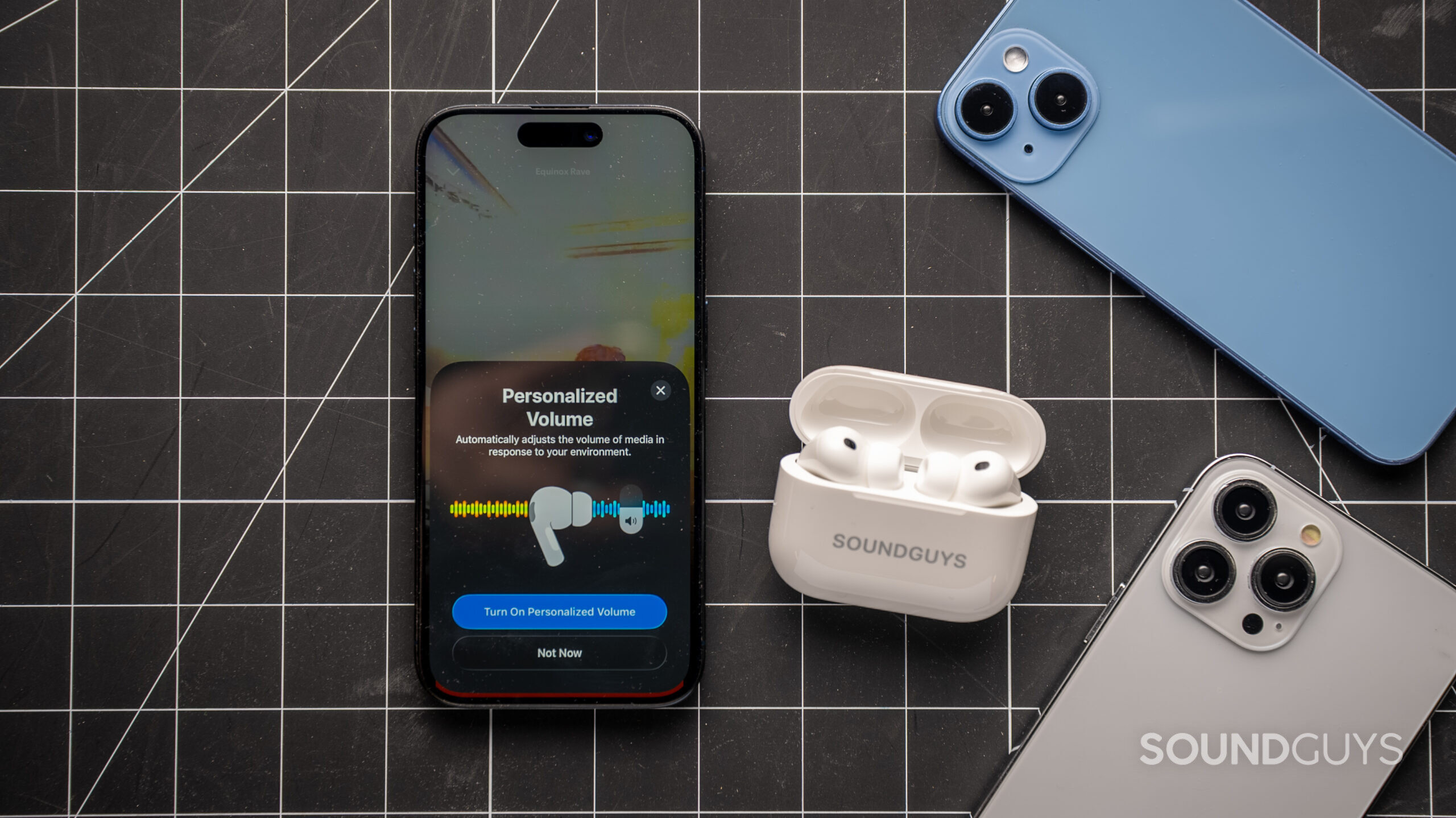 apple airpods pro 3 with iphones on table showing personalized voluem settings on screen