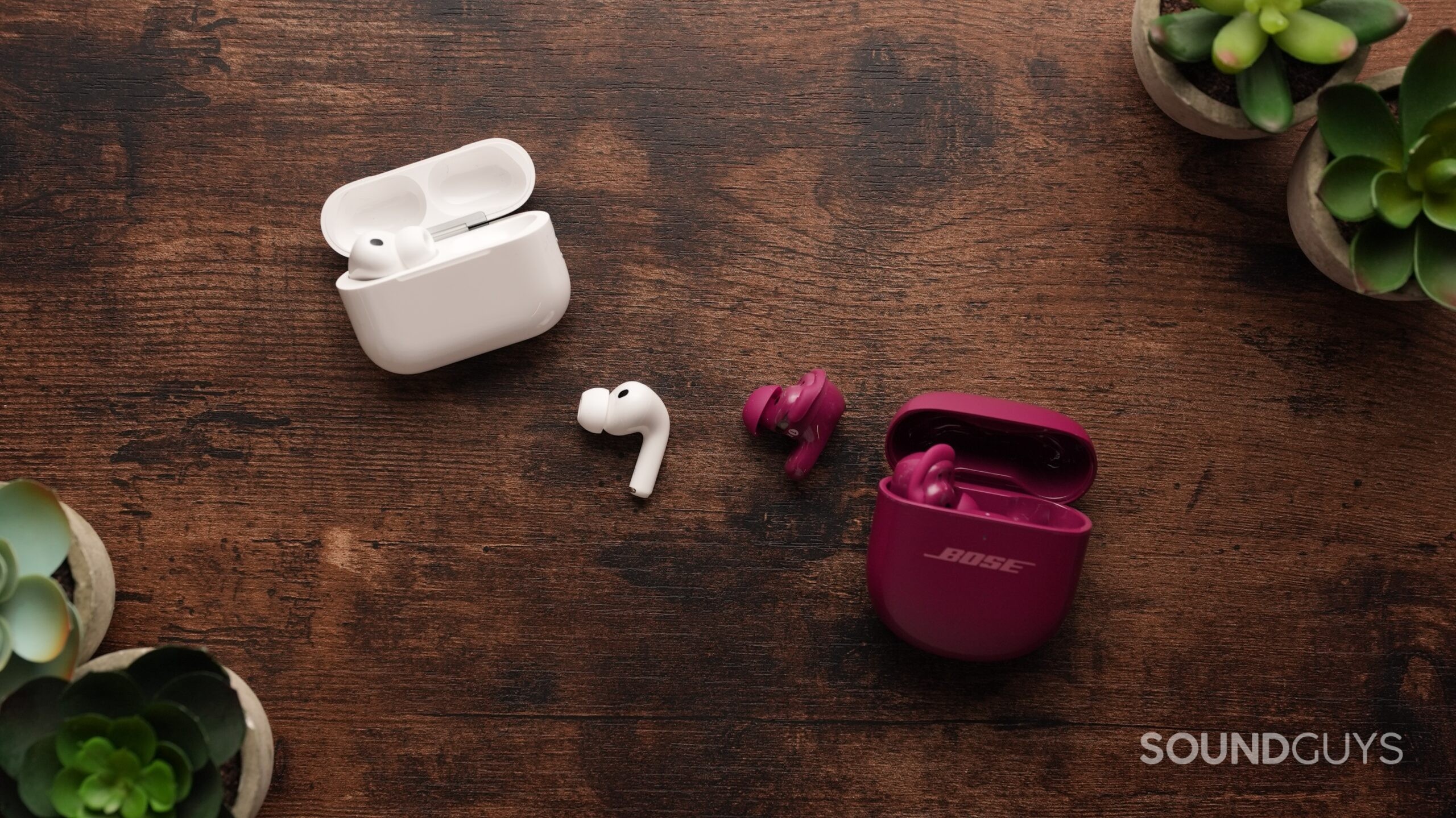 The AirPods Pro 3 and Bose QC Ultra 2 sit on a table. Each right earbud sits in the centre.