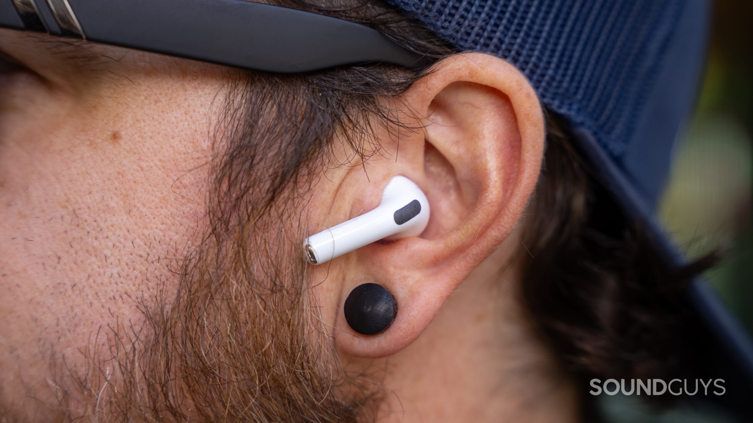 Close up of AirPods Pro 3 in man's ear.