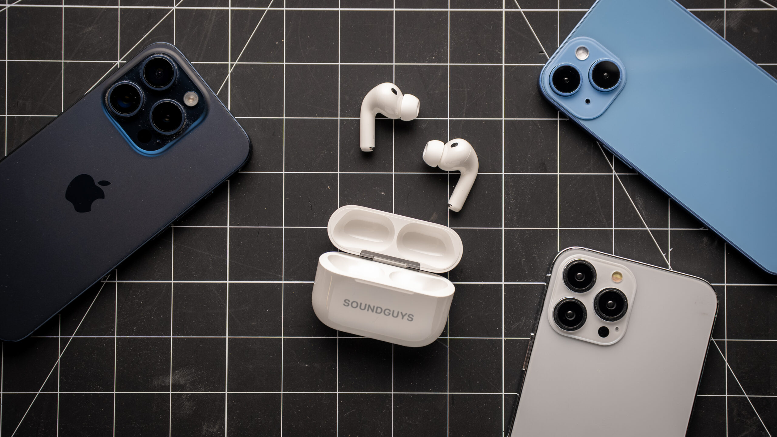 AirPods Pro 3 earbuds outside of the charging case laying on table.