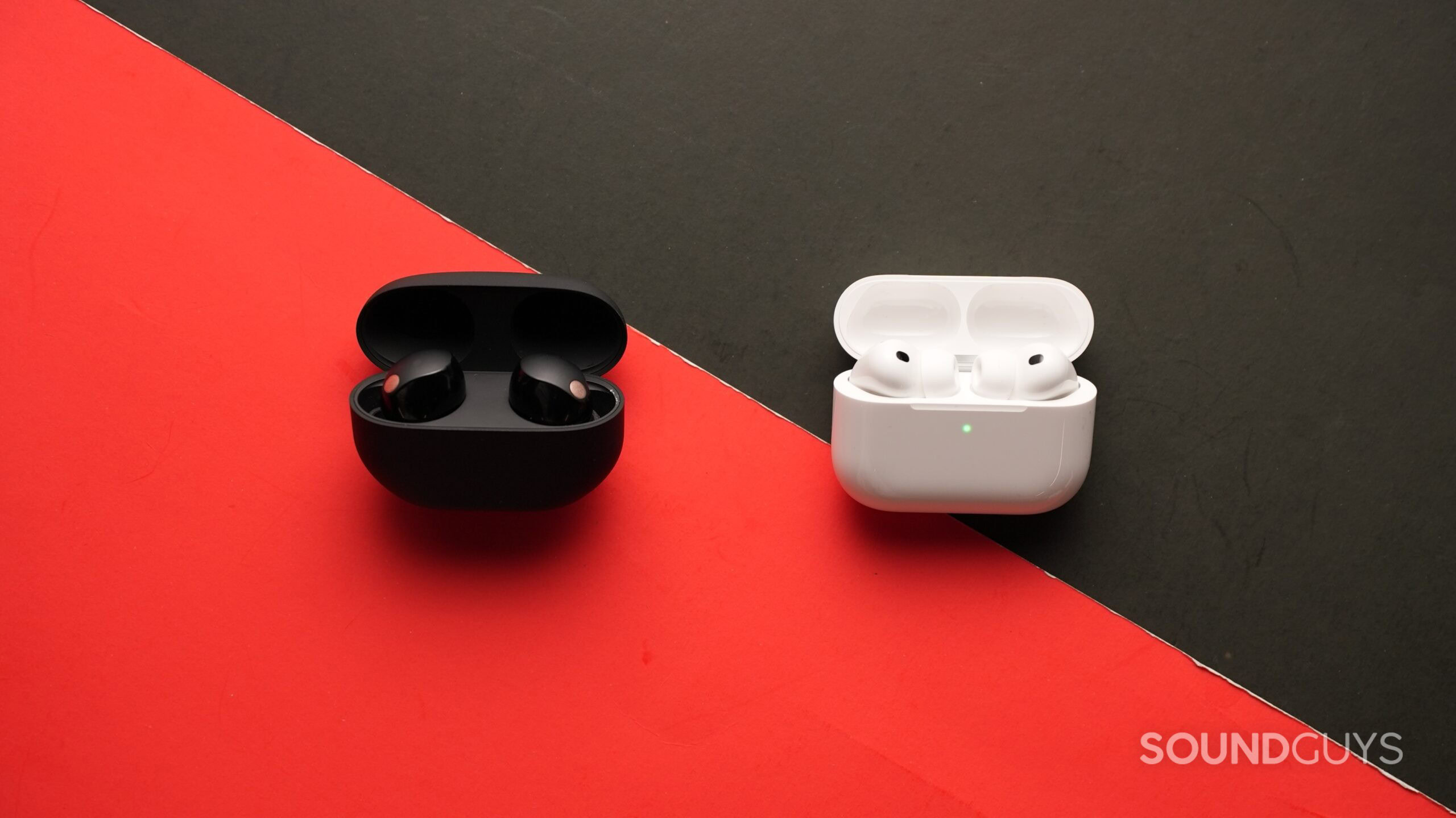 The AirPods Pro 3 and th Sony WF-1000XM5s sit on a table.
