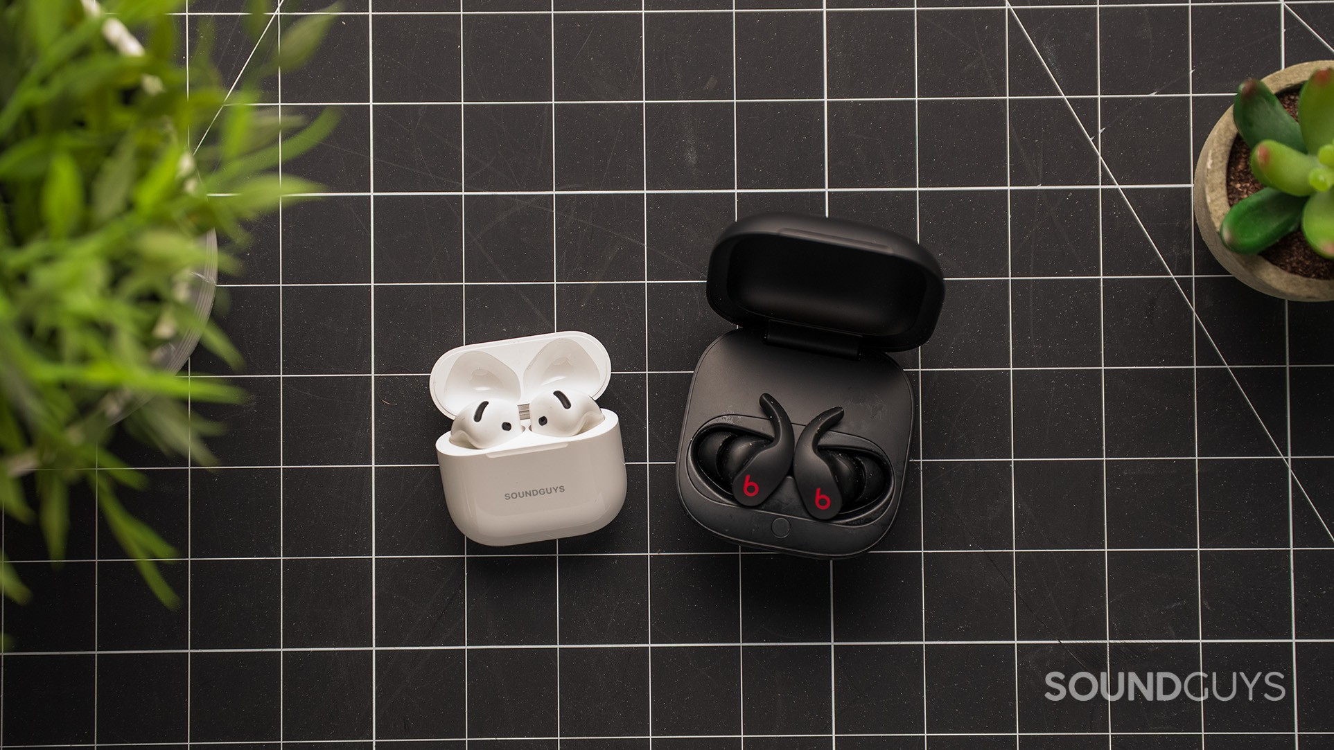 AirPods 4 next to Beats Fit Pro AirPods 4 next to Beats Fit Pro on a table.