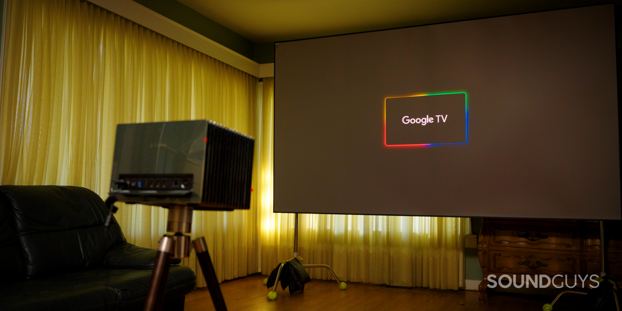 SG_Valerion VisionMaster Pro 2-16 Google TV loading screen on Valerion Visionmaster Pro 2 projector on Valerion Walnut Tripod Stand in living room with Valerion 120" Fresnel Ambient Light Rejecting Screen on stands