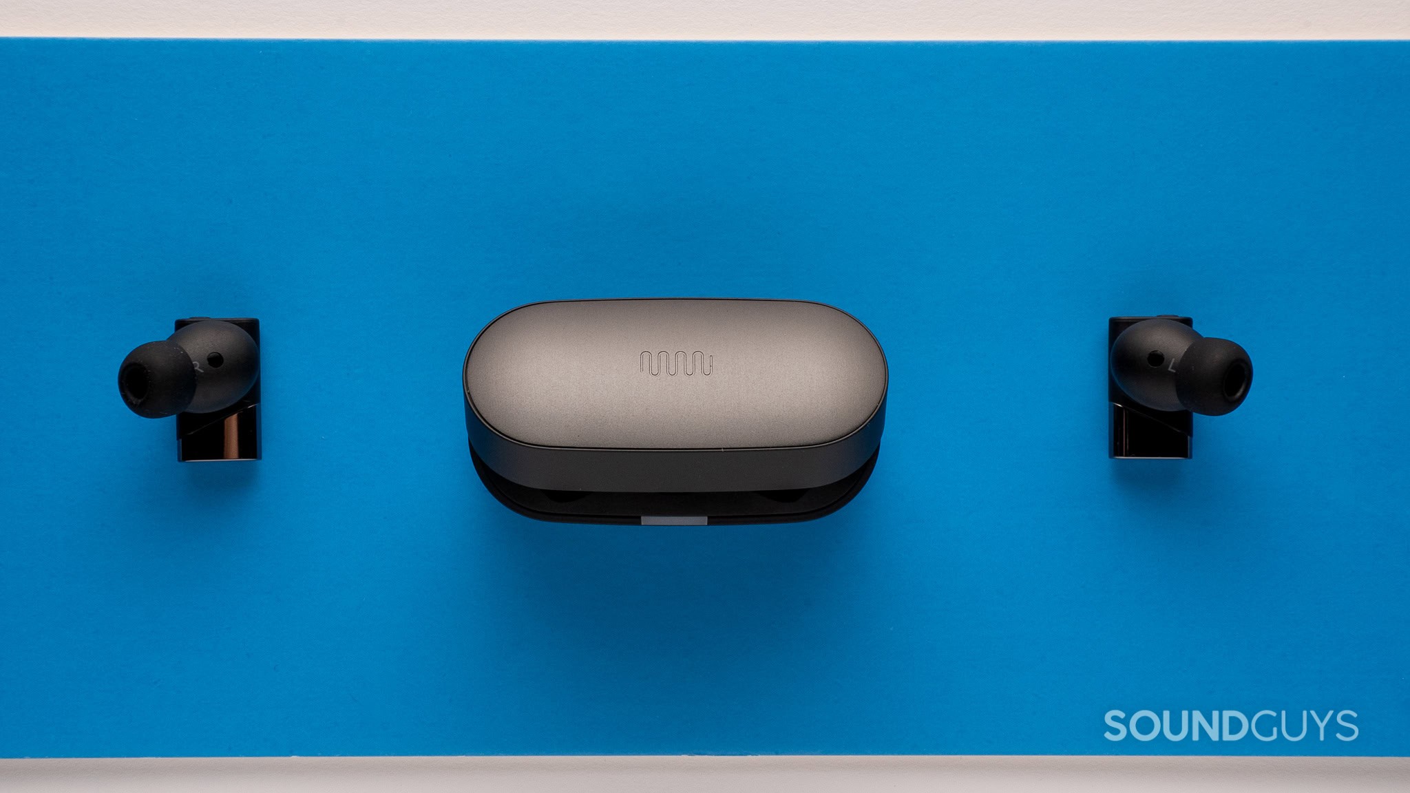 Status Pro X with the case in the center and an earbud flanking each side.