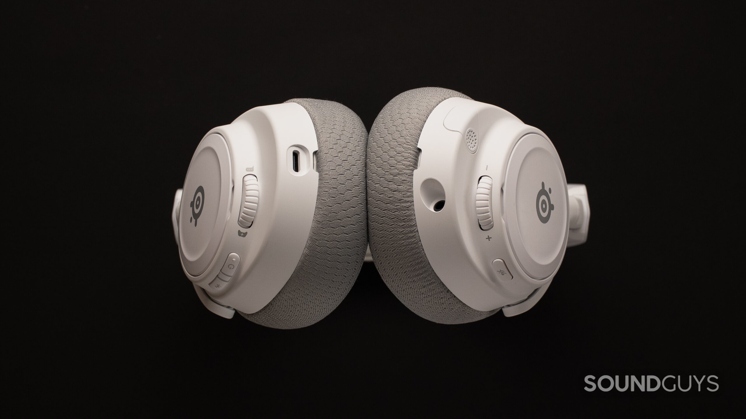 SteelSeries Arctis Nova 7 Gen 2 ports The SteelSeries Arctis Nova 7 Gen 2 from the bottom showing a USB-C port, a 3.5mm port, two wheels, and multiple buttons for mute, power, and Bluetooth.