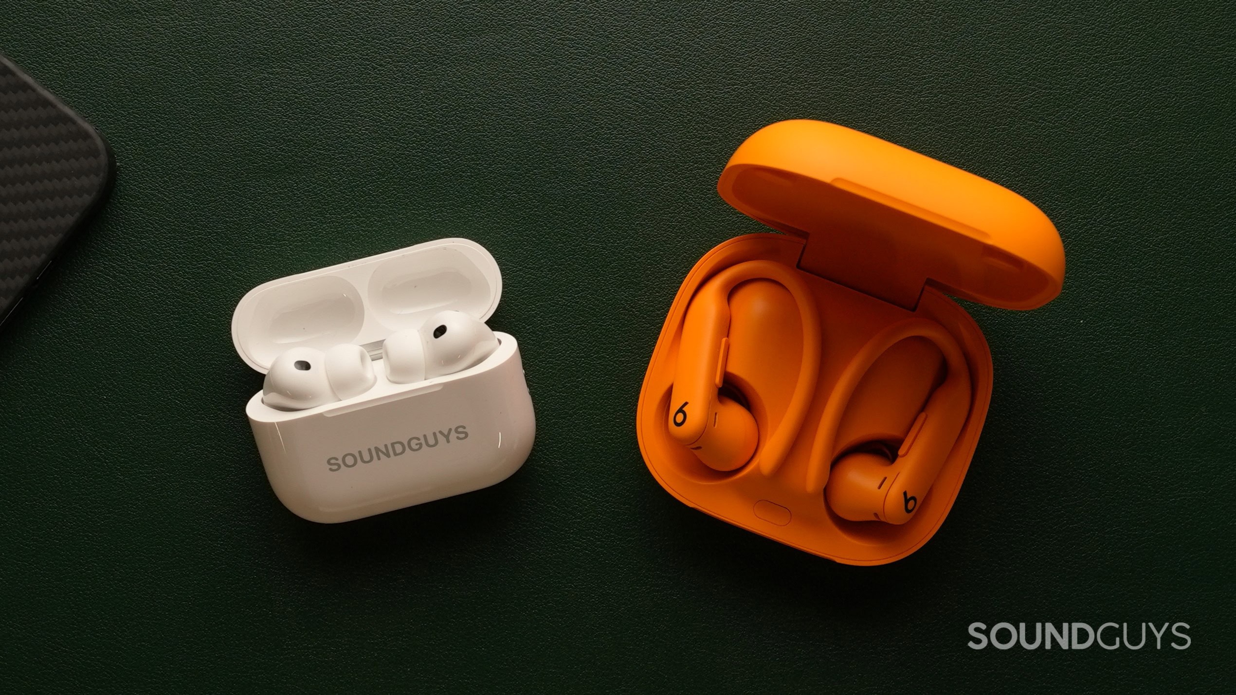 A photograph of the Apple AirPods Pro 3 and Powerbeats Pro 2 in their charging cases.