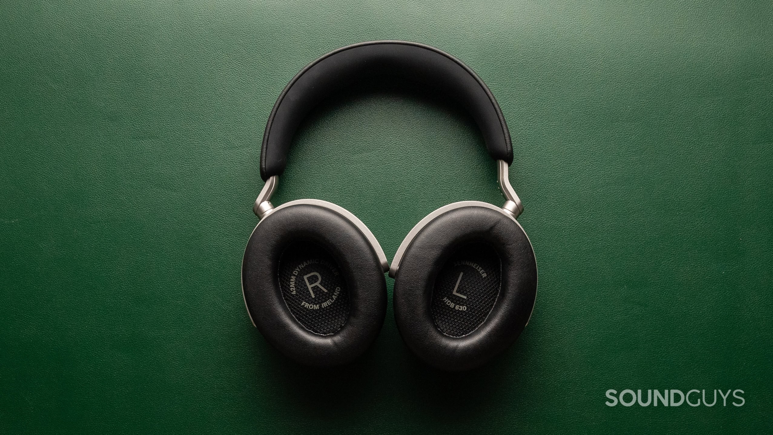 sennheiser hdb 630003 A photo of the Sennheiser HDB 630 with ear cups facing the viewer on a green leather background.