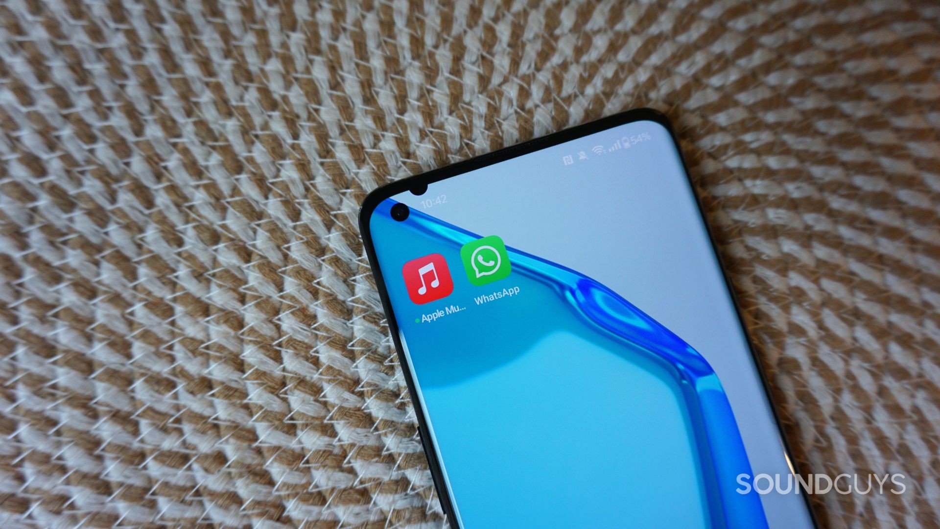 A photograph of the Apple Music and WhatsApp mobile apps.