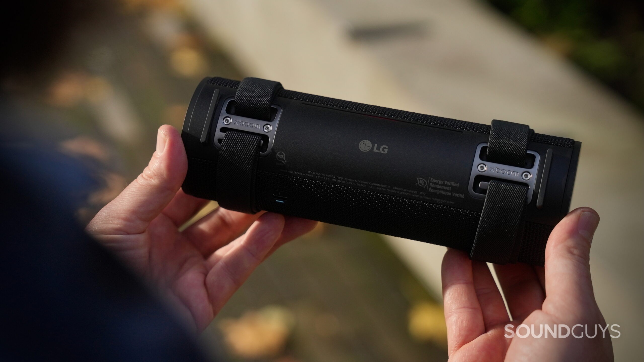 Photo of the rear side of the LG xboom Grab speaker, showing its attachment straps.