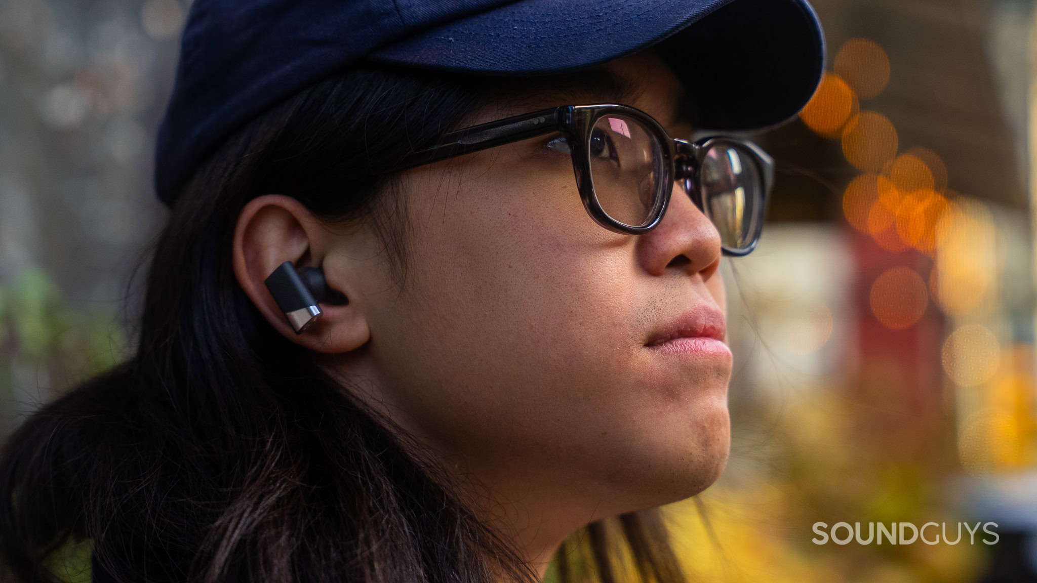 Status Pro X Worn outside by a man with long hair wearing a cap.