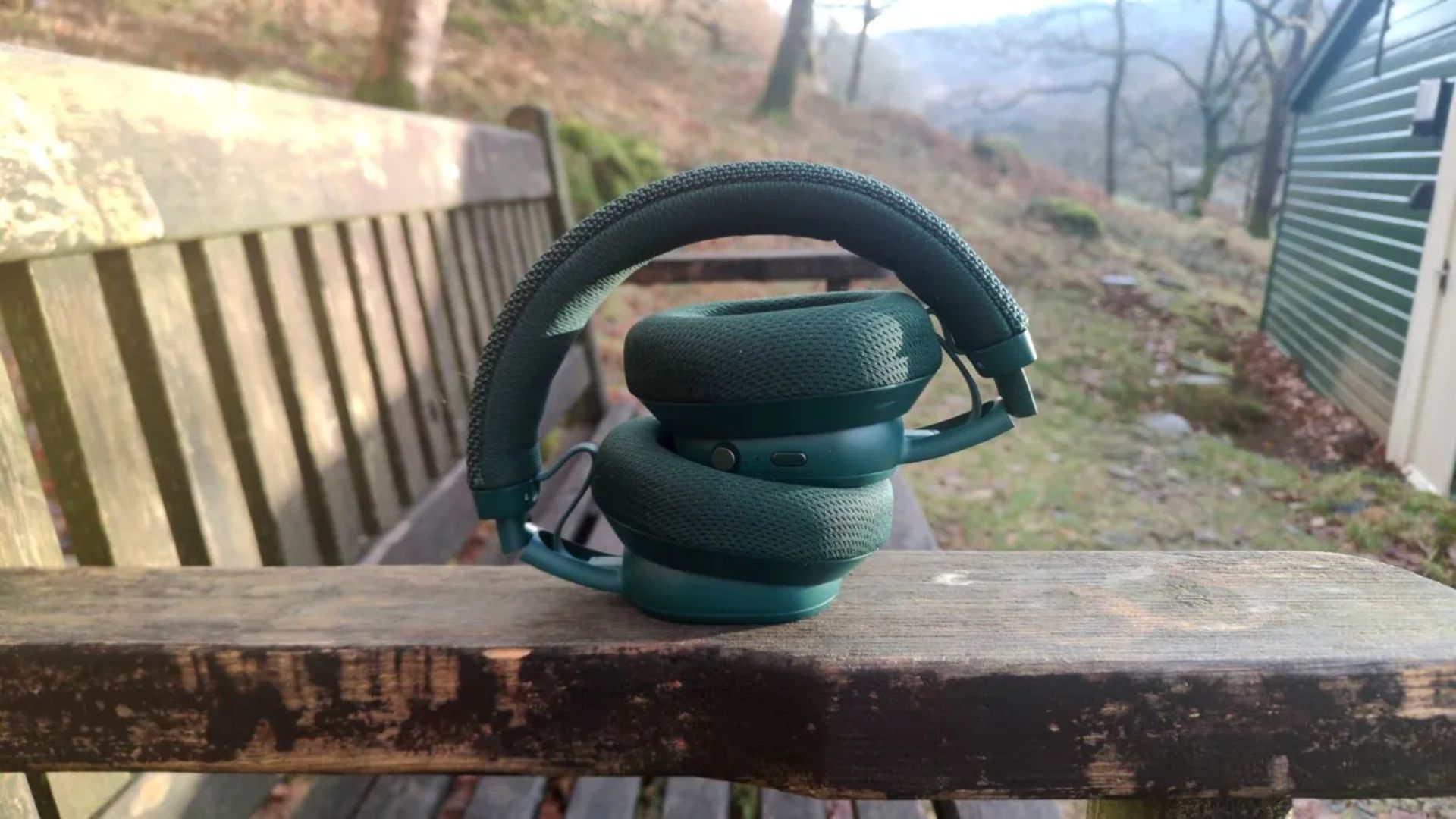 Fairphone-Fairbuds-XL-2025-foldable-ear-cups A photograph of the Fairphone Fairbuds XL (2025) on a bench.