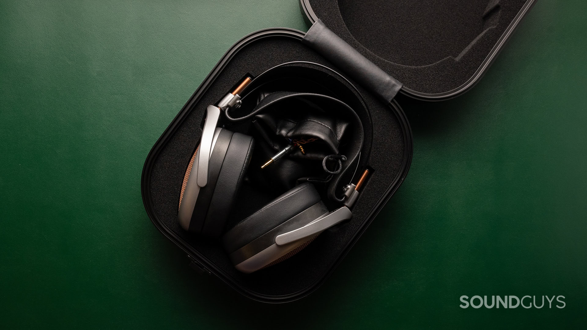A photo of the Meze Audio Poet in its travel hardshell case.