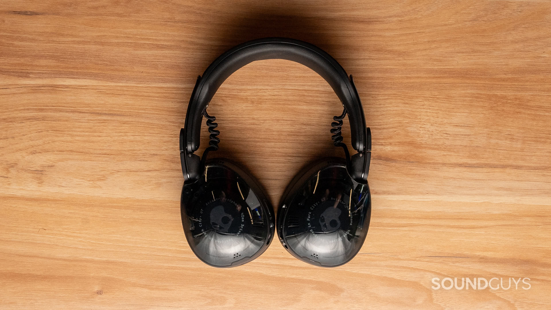 A top-down photo of the Skullcandy Aviator 900 ANC on a wooden desk.