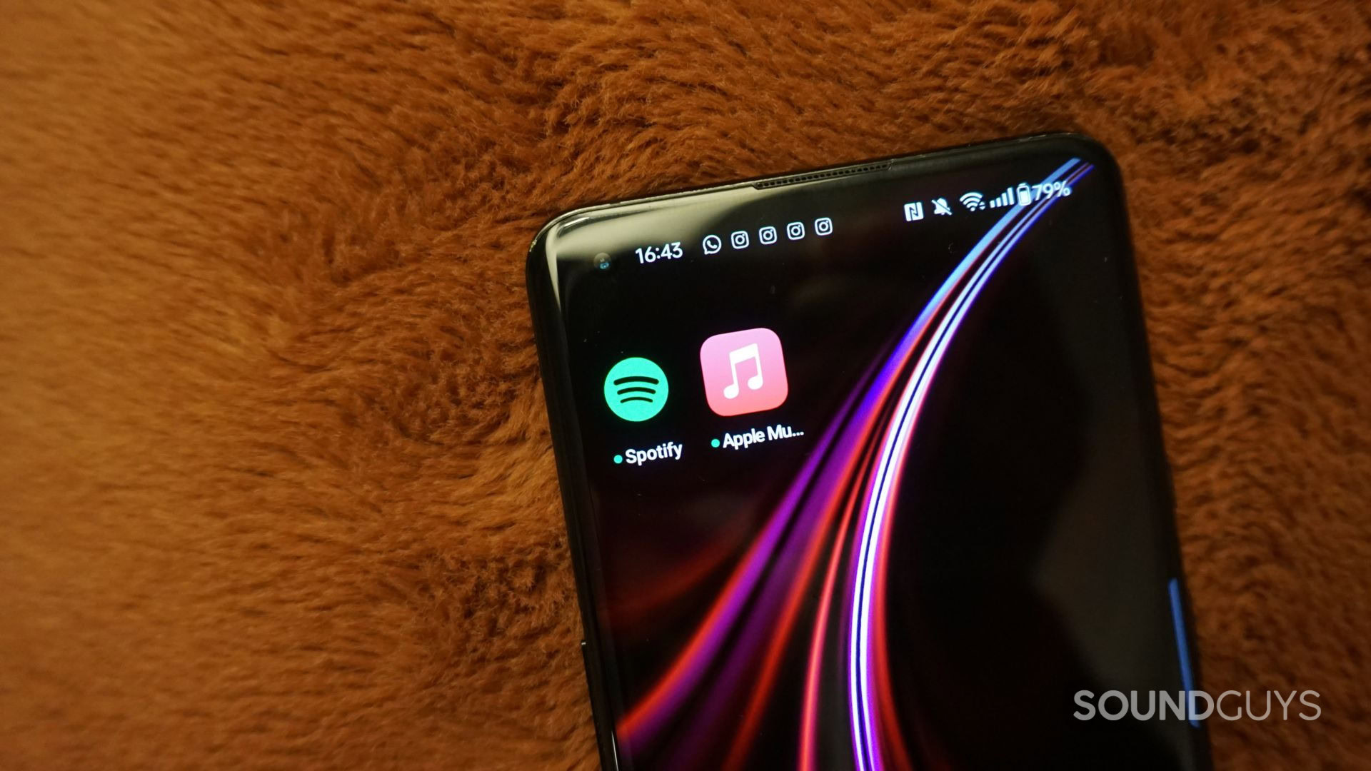 A photograph of the Spotify and Apple Music mobile apps.