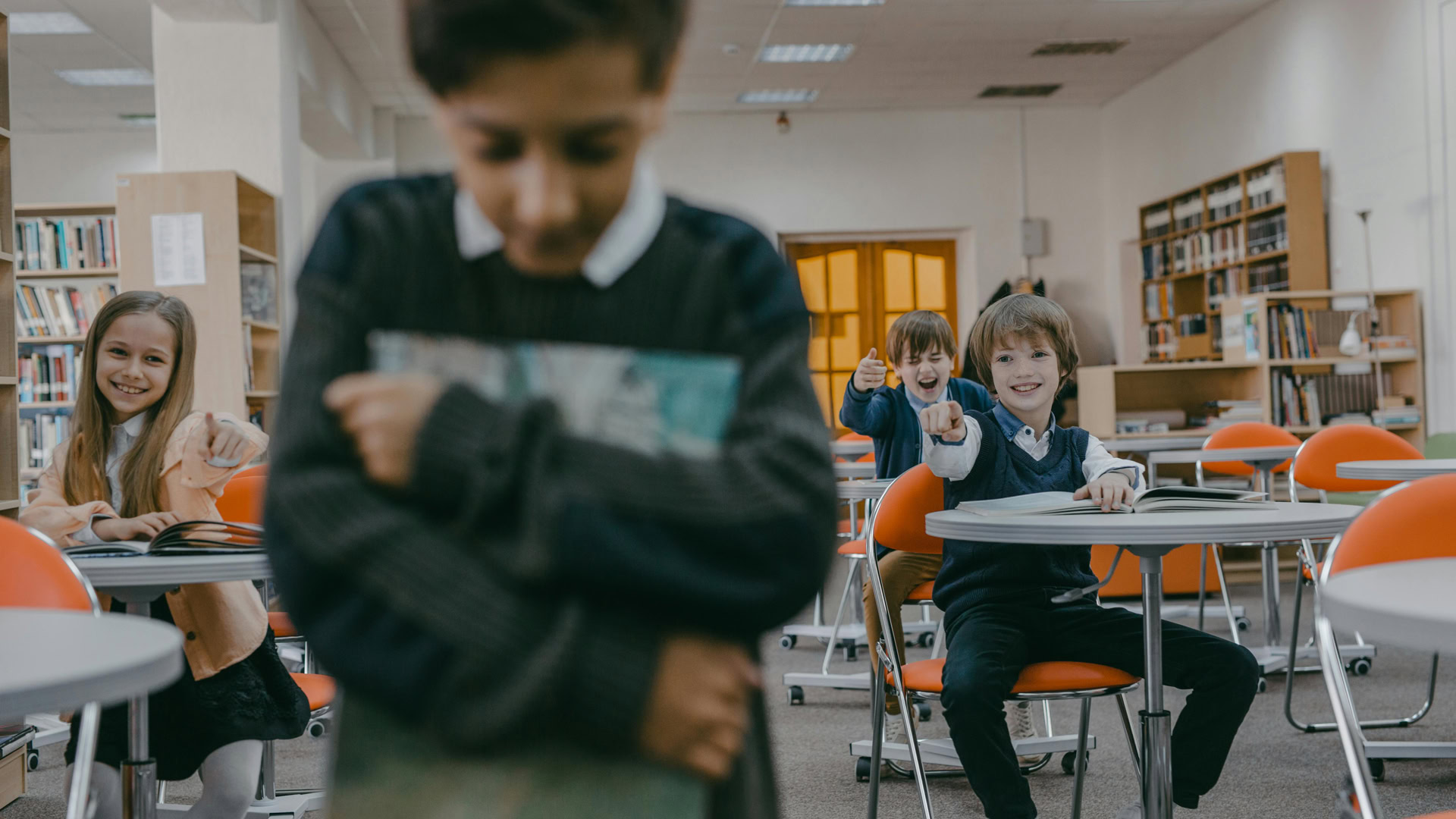 burn-in-part-3-brain-point-and-laugh A young boy defocused in the foreground is mocked by classmates in the background.
