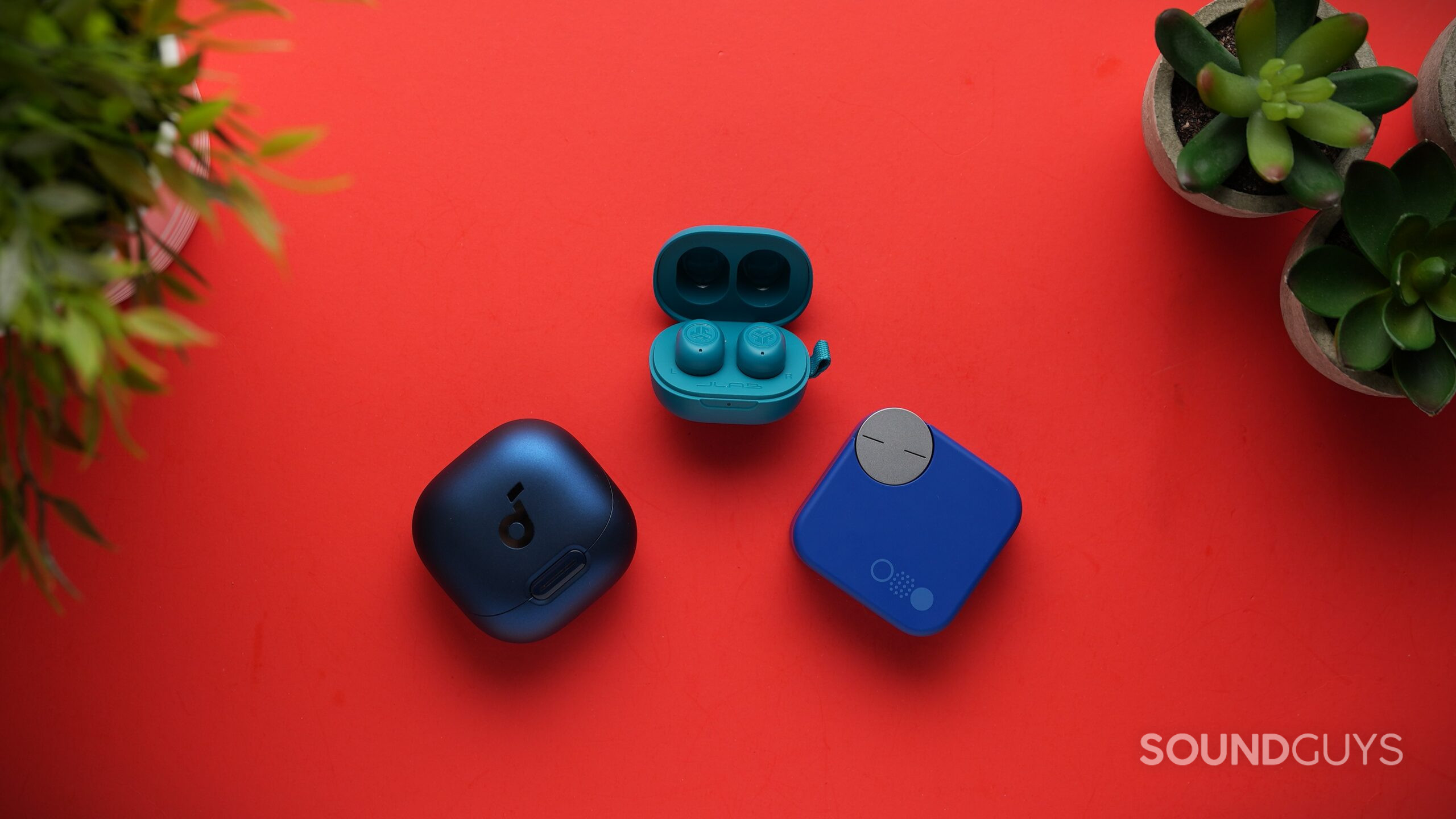 earbuds xmas 2025 three wireless earbuds on red background with plants