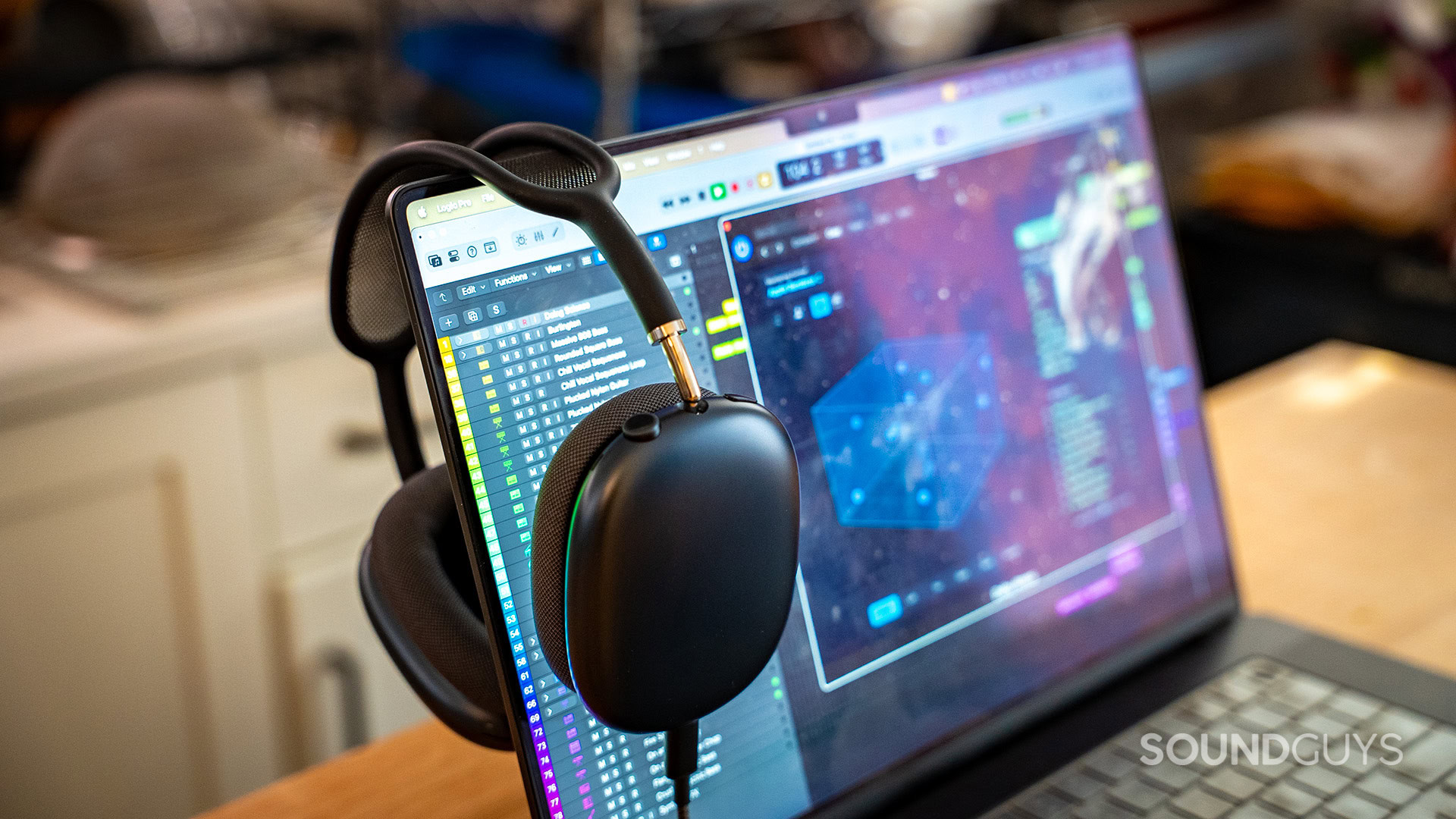 AirPods Max USB-C on laptop with spatial audio mixing logic pro x AirPods Max hanging on a MacBook Pro monitor with Logic Pro X on screen showing spatial audio mix