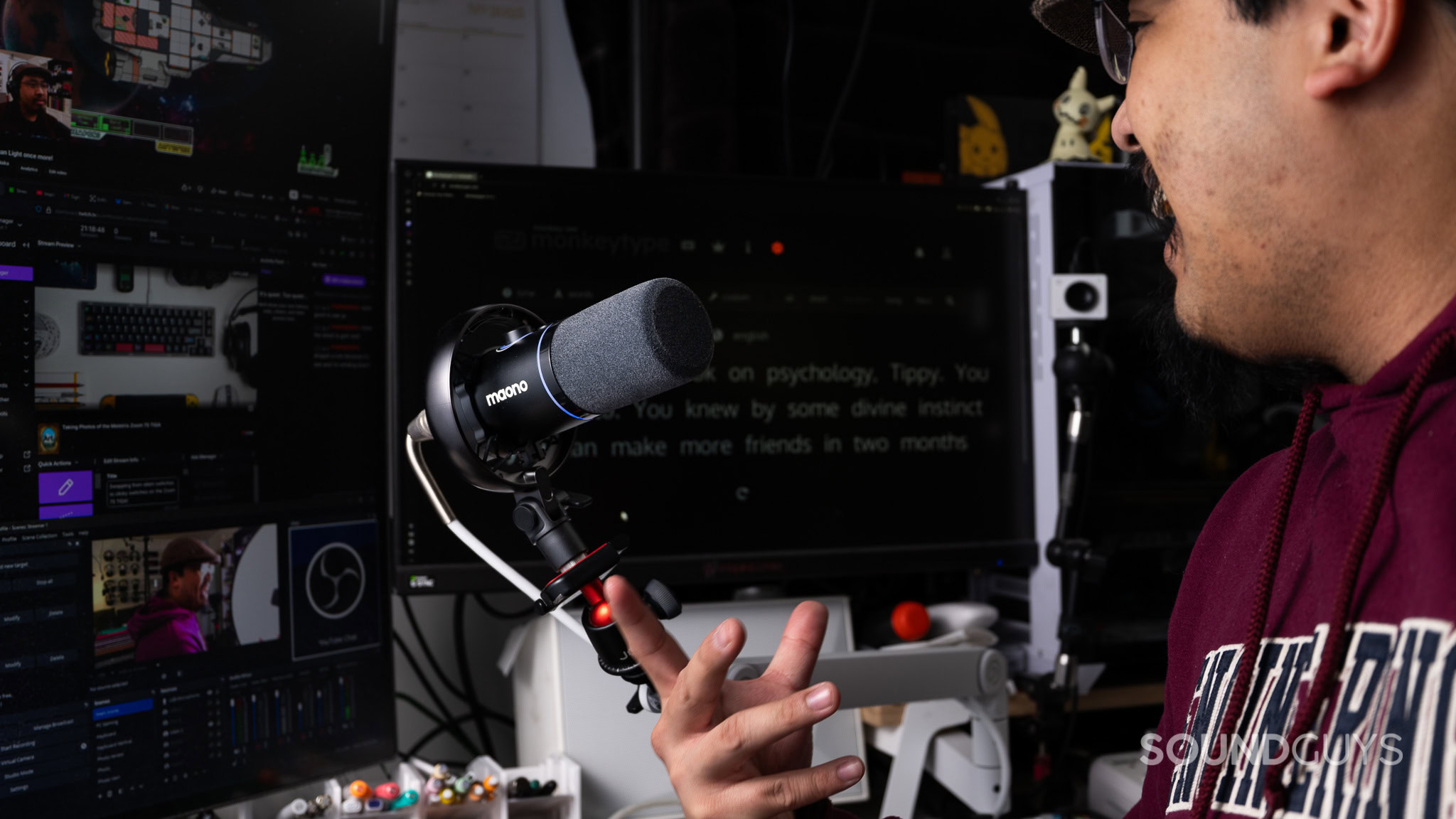 Maono PD200W streaming Maono PD200W streaming microphone in front of multiple monitors mid stream.