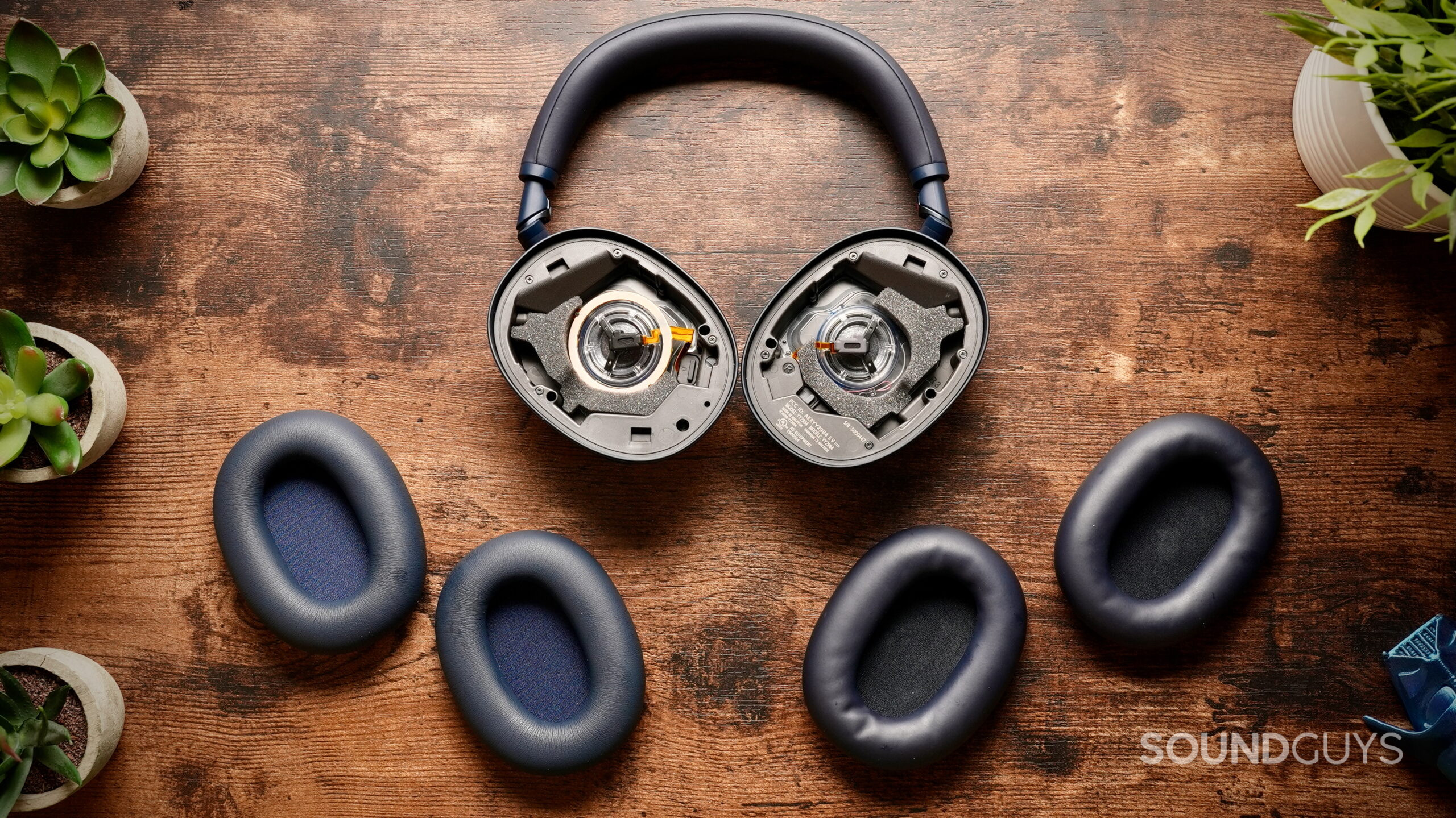 WH-1000XM6 Wicked Cushions - 1 Overhead view of Sony WH-1000XM6 headphones with stock ear pads and Wicked Cushions replacement pads laid out for comparison.