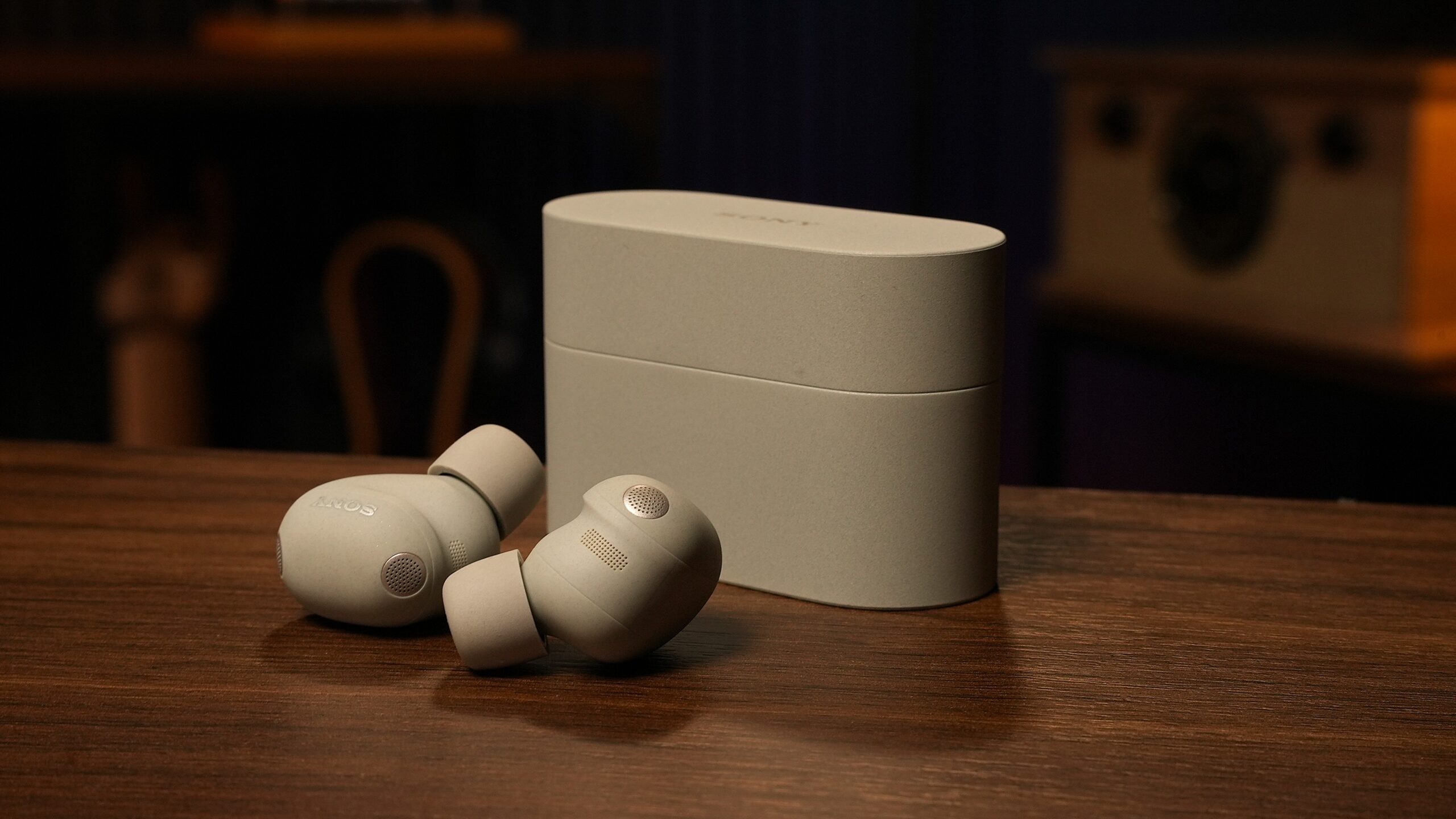 sony wf-1000xm6 warbuds with case on wood table sony wf-1000xm6 warbuds with case on wood table