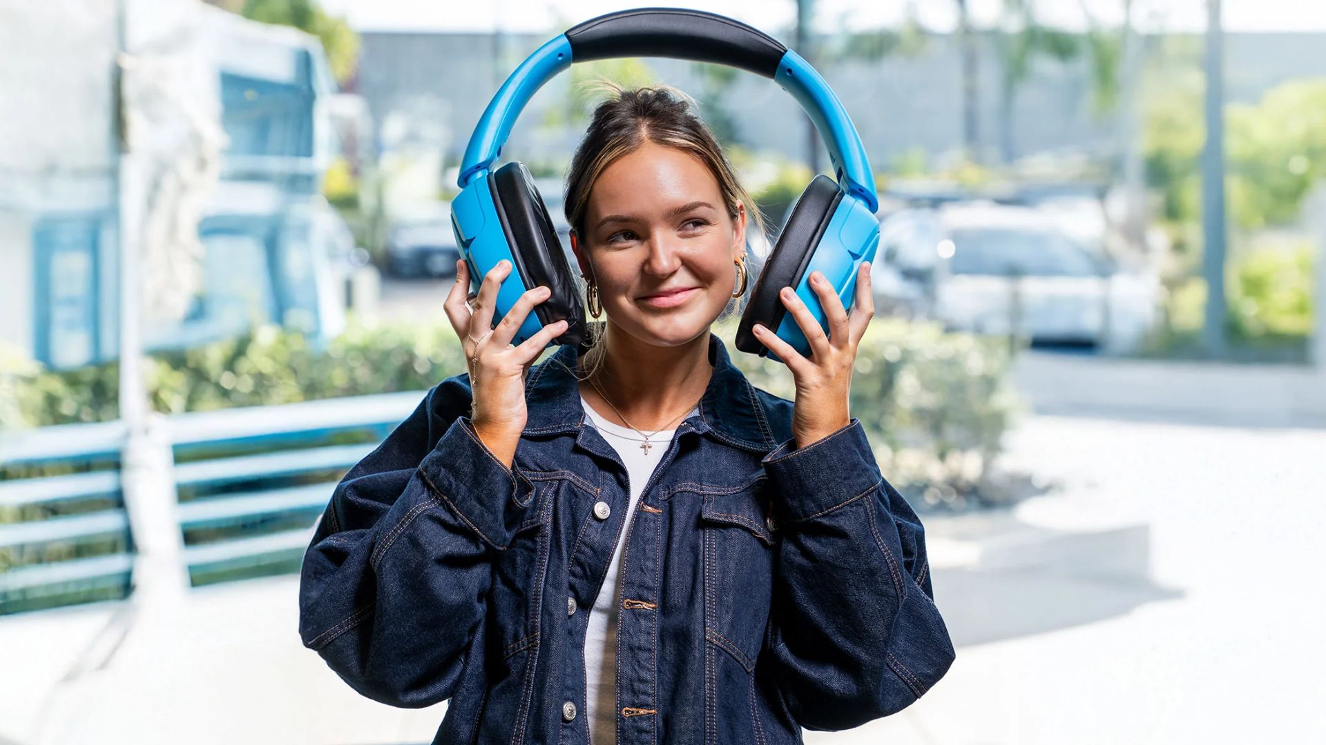 JLab-Blue-XL-Speaker-Headphones A photograph of the JLab Blue XL Speaker Headphones being worn.