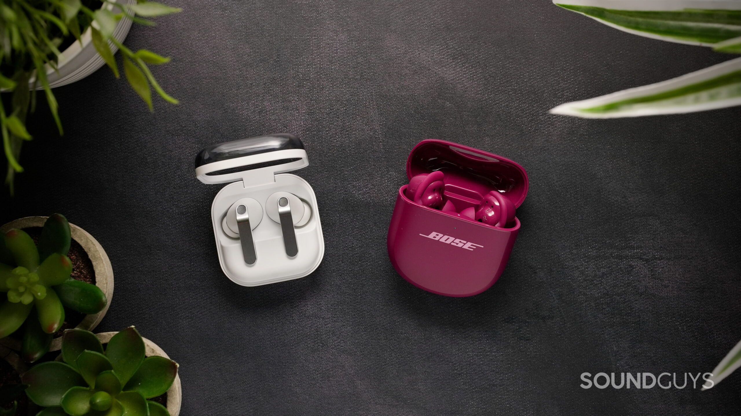 Samsung Galaxy Buds 4 Pro and Bose QuietComfort Ultra Earbuds with open charging cases on a black background.