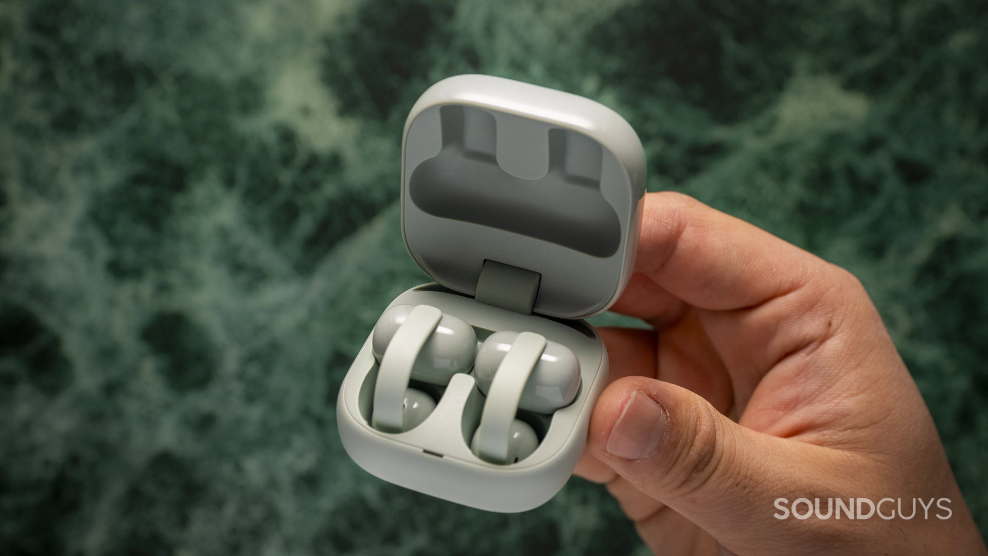 A photgraph of someone holding the Sony LinkBuds Clip.