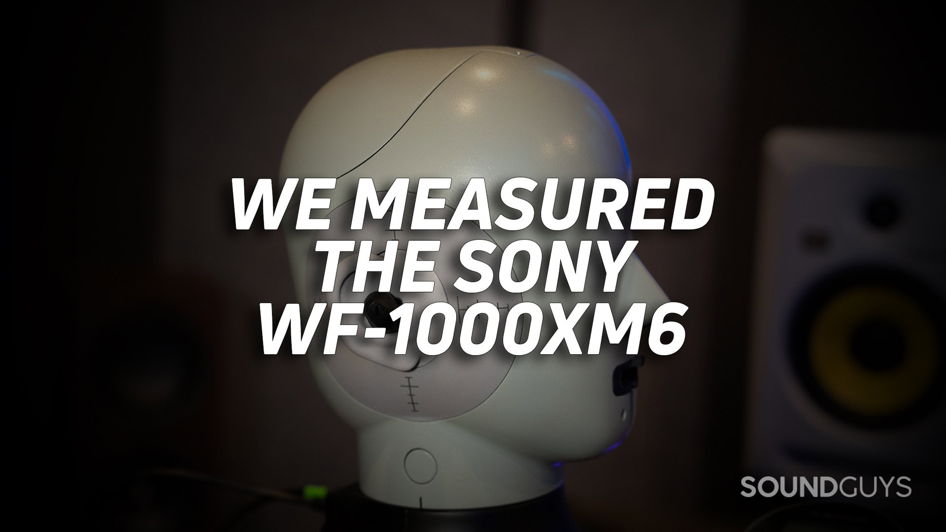 SONY-WF-1000XM6-MEASUREMENTS-HERO A photo of a headphone measuring robot in a dark room.