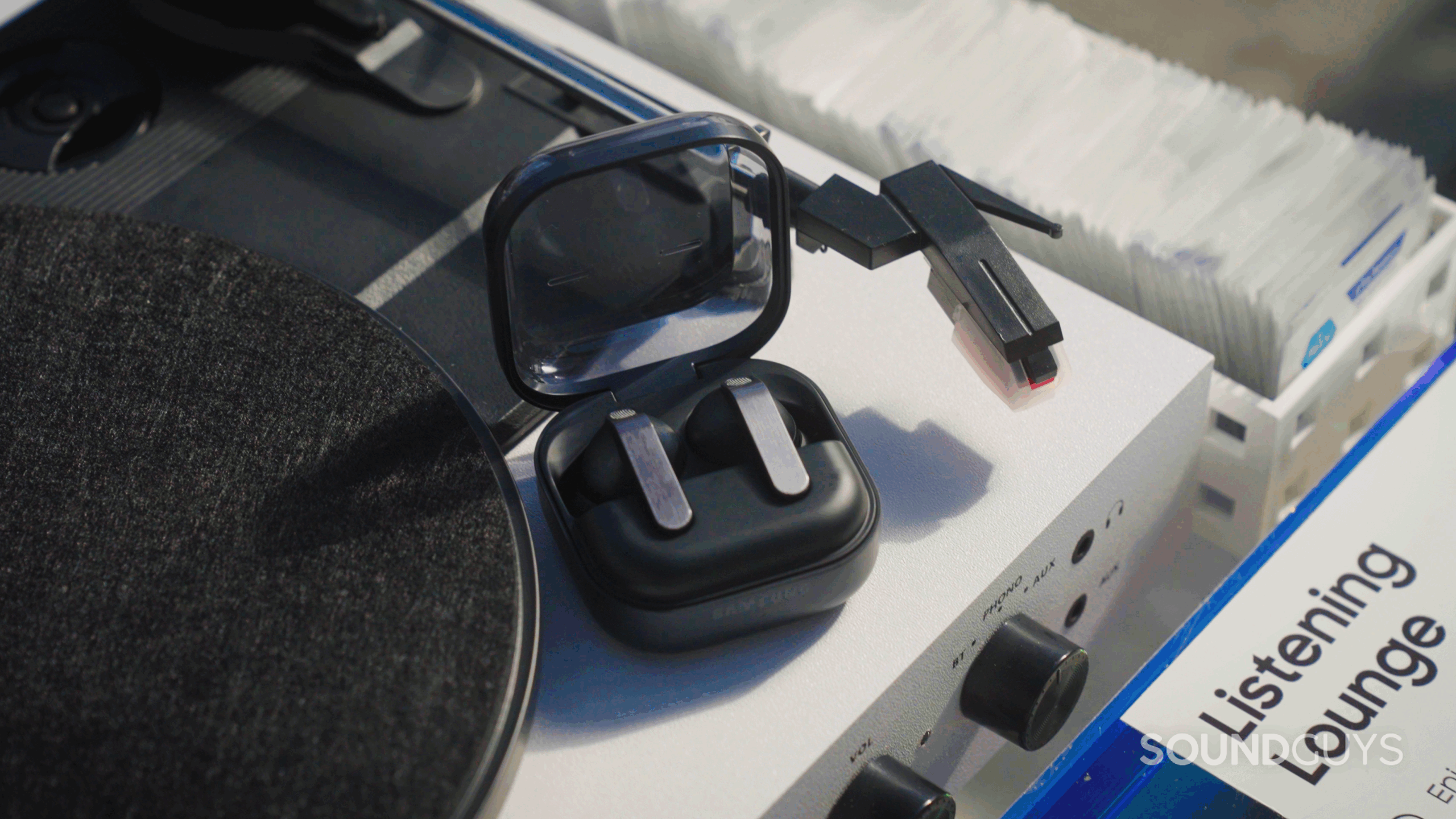 Samsung Galaxy Buds 4 vs 4 Pro_Still 10 Samsung Galaxy Buds4 Pro beside a turntable