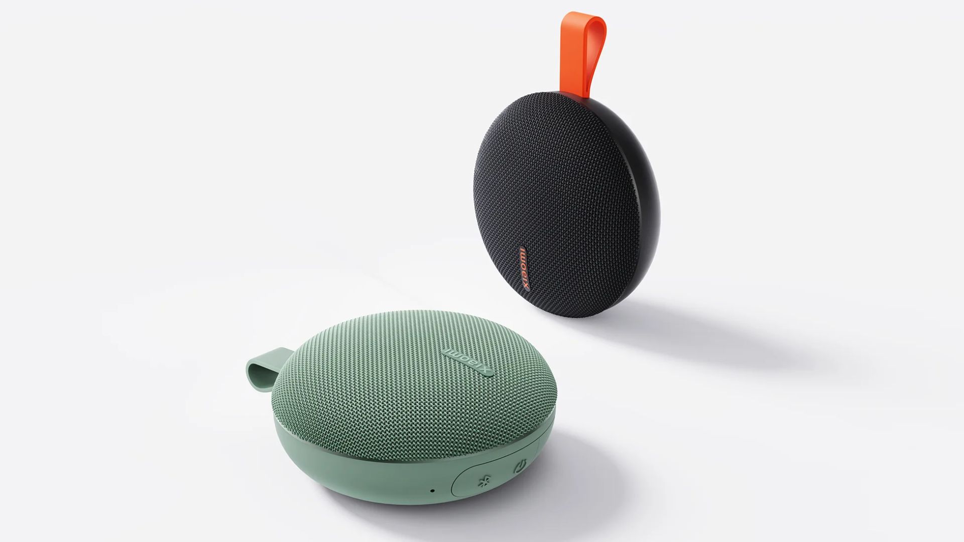 Xiaomi-Bluetooth-Speaker-Essential-color-variants A photograph of two Xiaomi Bluetooth Essential Speaker systems.