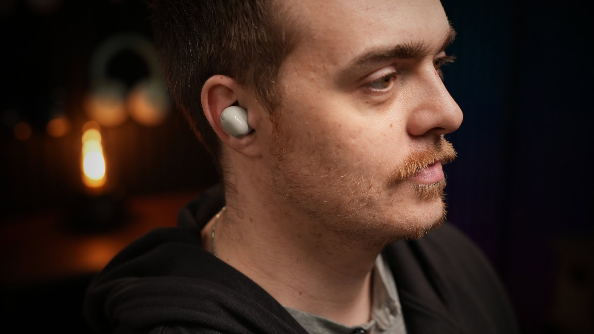 a-man-listening-to-the-sony-wf-1000xm6-earbuds A man wears Sony WF-1000XM6, presumably on low battery.