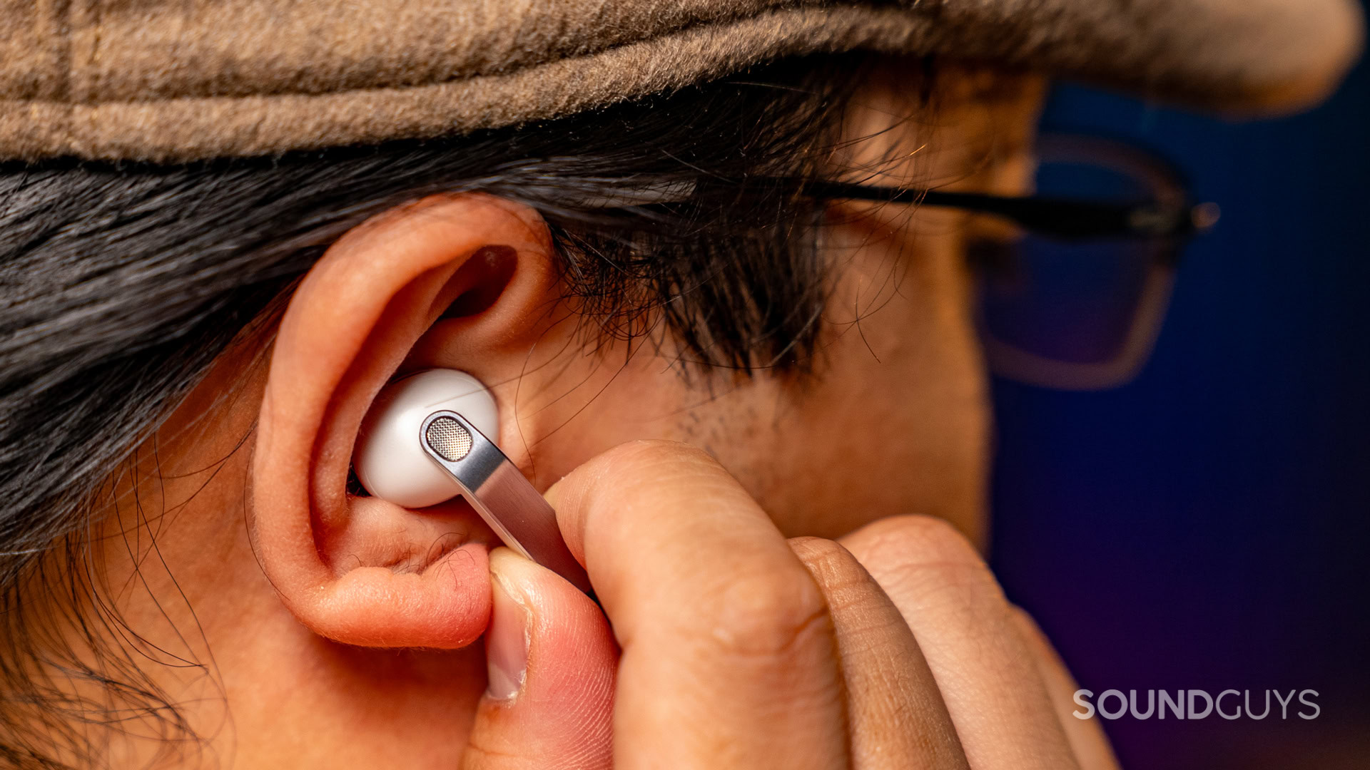 A man controls the Samsung Galaxy Buds 4 Pro by pinching the right stem.