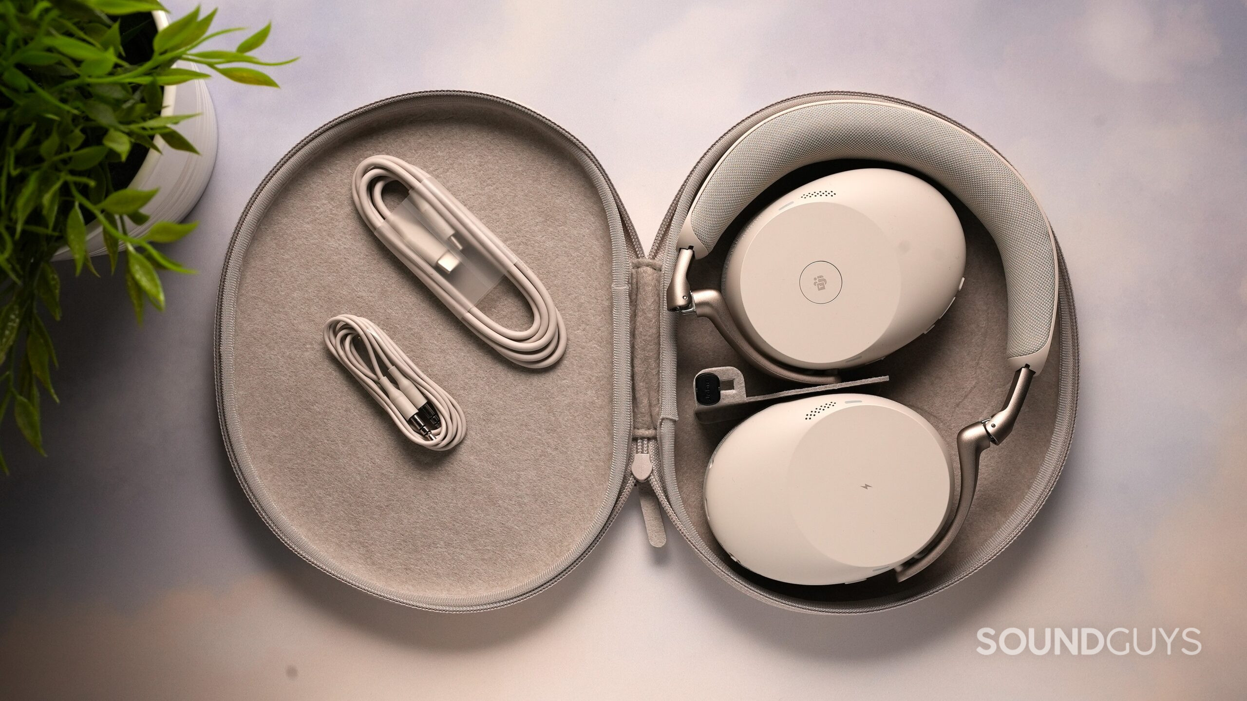 DSC09456 Jabra Evolve3 85 white over-ear headphones inside an open fabric carrying case, with USB-C and audio cables neatly stored beside them.