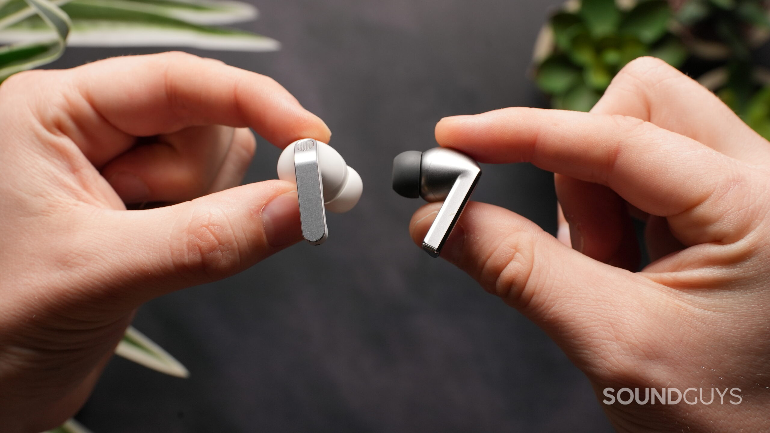 holding the Galaxy Buds 4 Pro vs 3 Pro earbuds