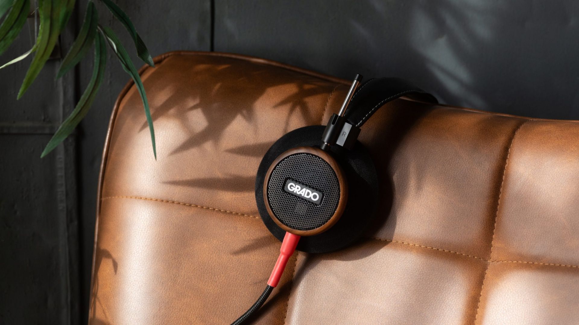 A photograph of the Grado Labs Signature S550 resting on a sofa.