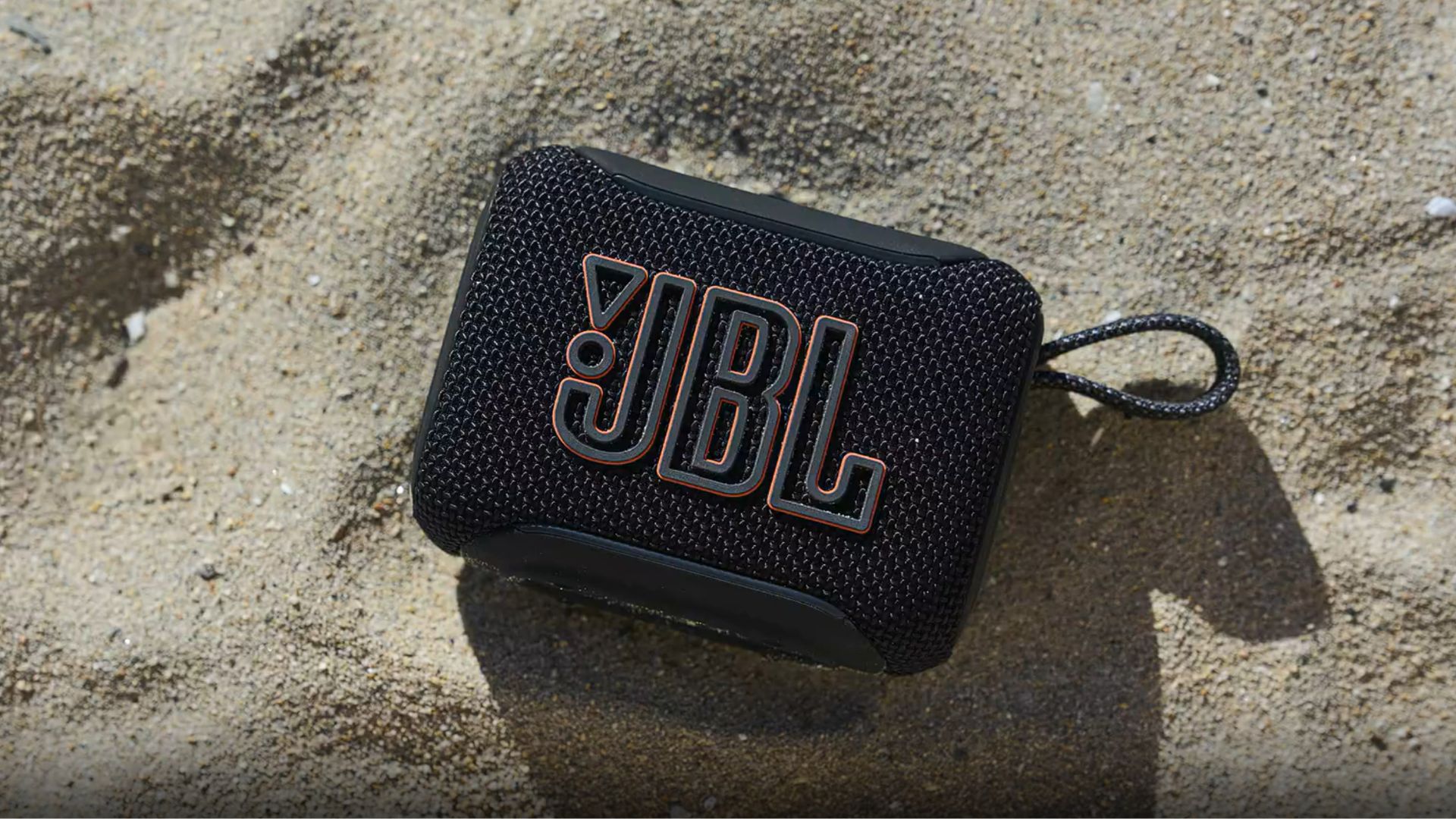 JBL-Go-5-IP68-rating A photograph of the JBL Go 5 resting on sand.