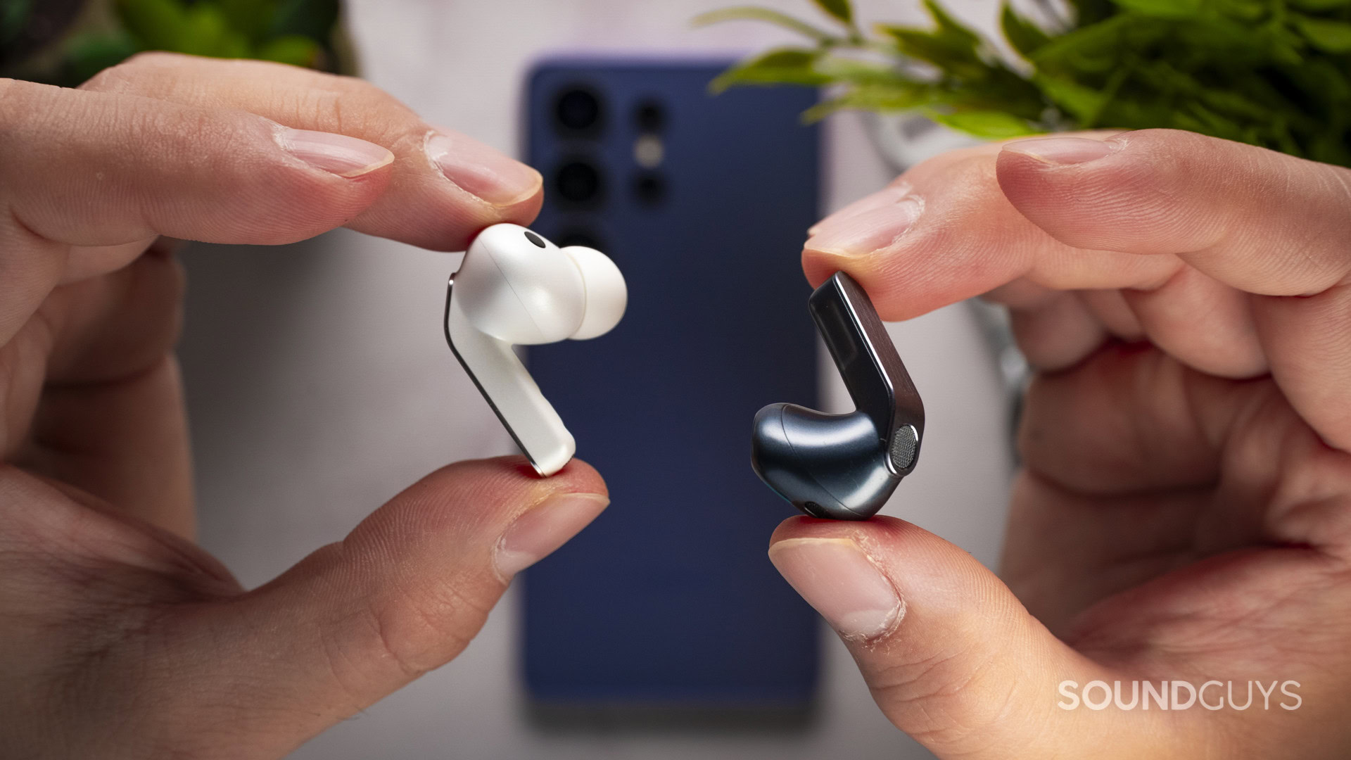 Holding the Samsung galaxy buds 4 and 4 pro earbuds