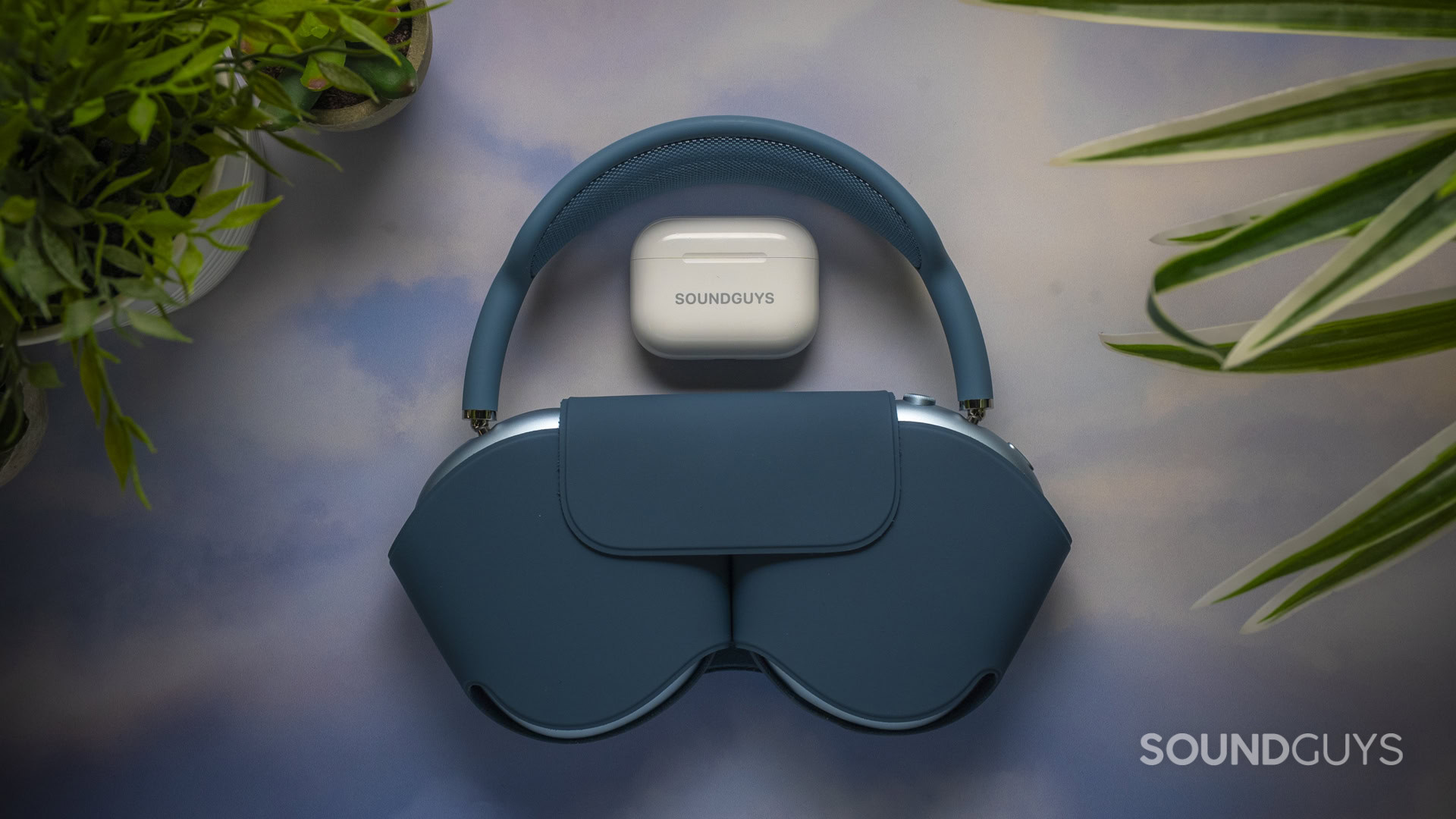 Apple AirPods Max 2 in the Smart Case next to the AirPods Pro 3 charging case on a tabletop.