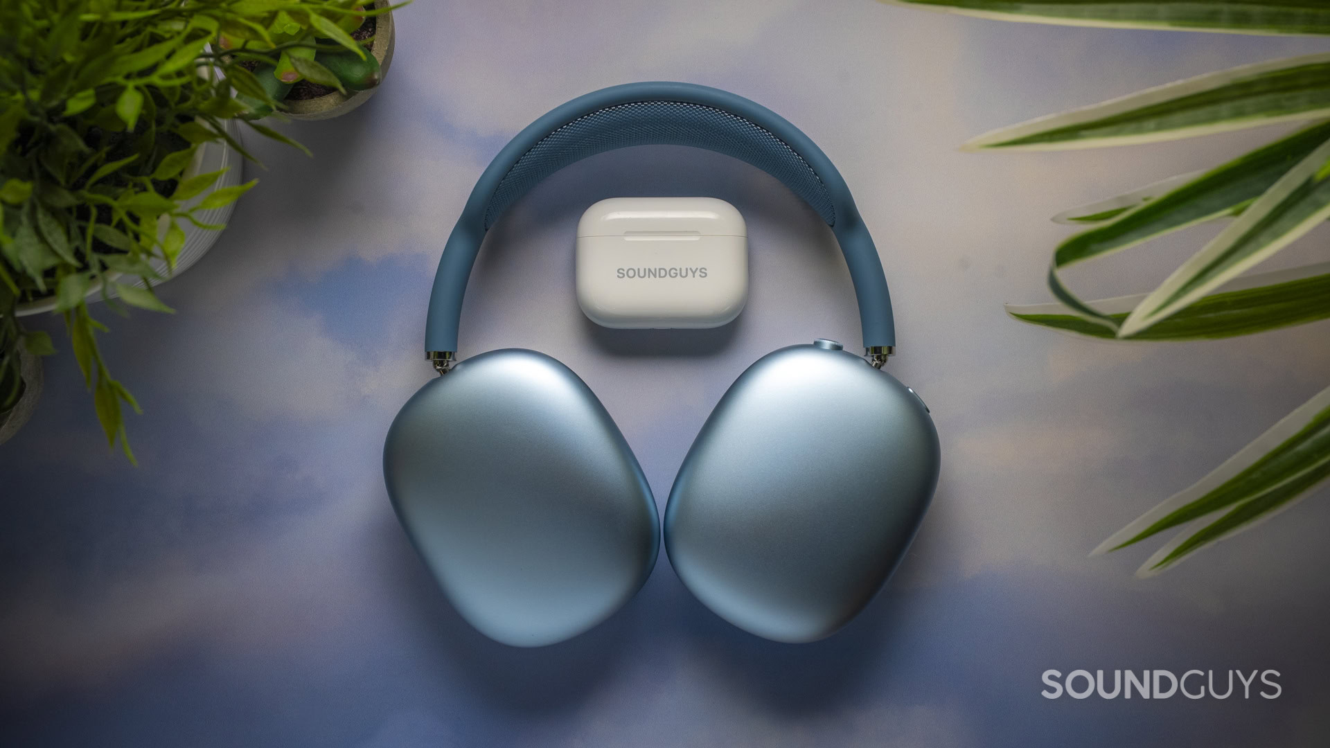 Apple AirPods Max 2 headphones next to AirPods Pro 3 charging case.
