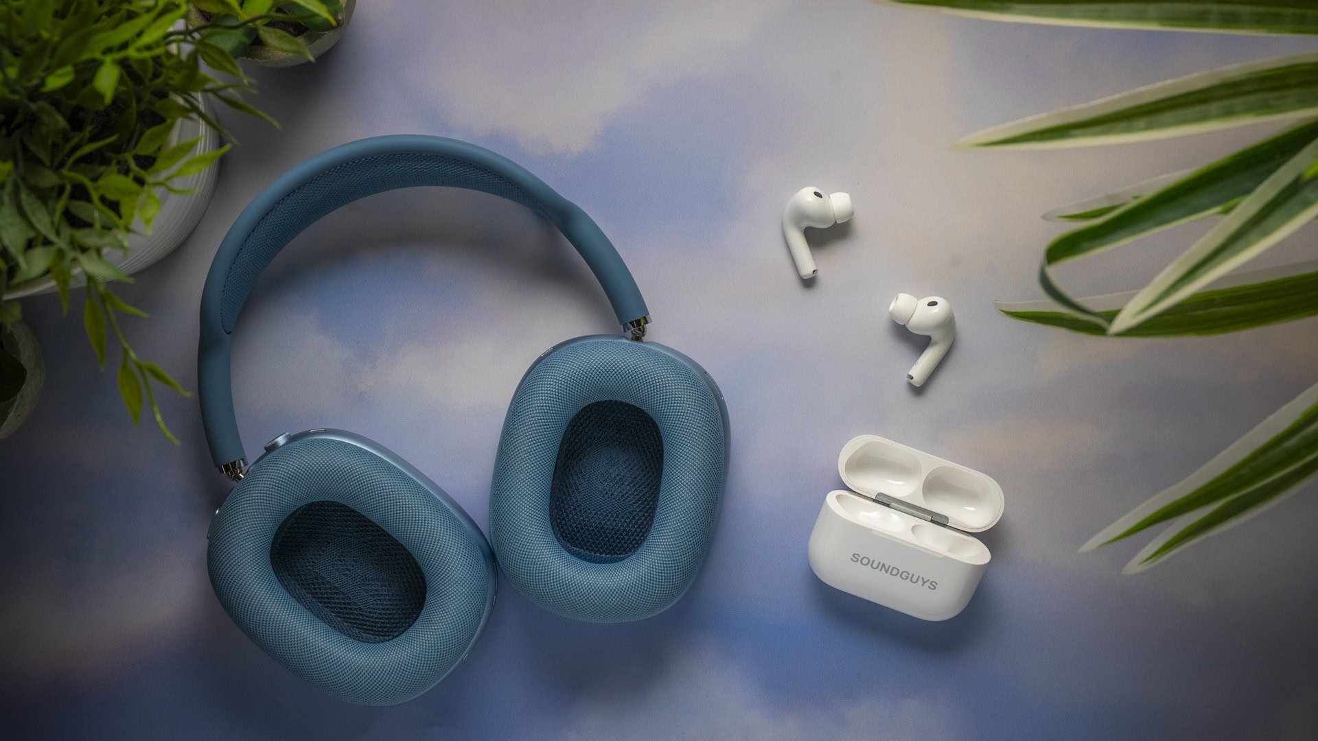 Apple AirPods Max 2 ear cushions next to the AirPods Pro 3 earbuds and charging case.